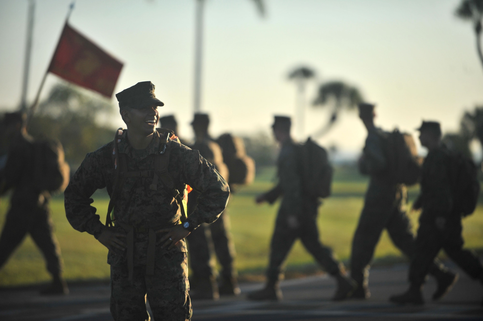 A Marine assigned to the U.S Marine Corps Forces Central Command stands in the road to act as a road guard during a 12 mile hike at MacDill Air Force Base, Fla., Nov. 10, 2016. Road guards were placed anytime the Marines crossed an active roadway during their 12-mile hike to honor the Marine Corps 241st birthday. (U.S. Air Force Photo by Airman 1st Class Rito Smith)