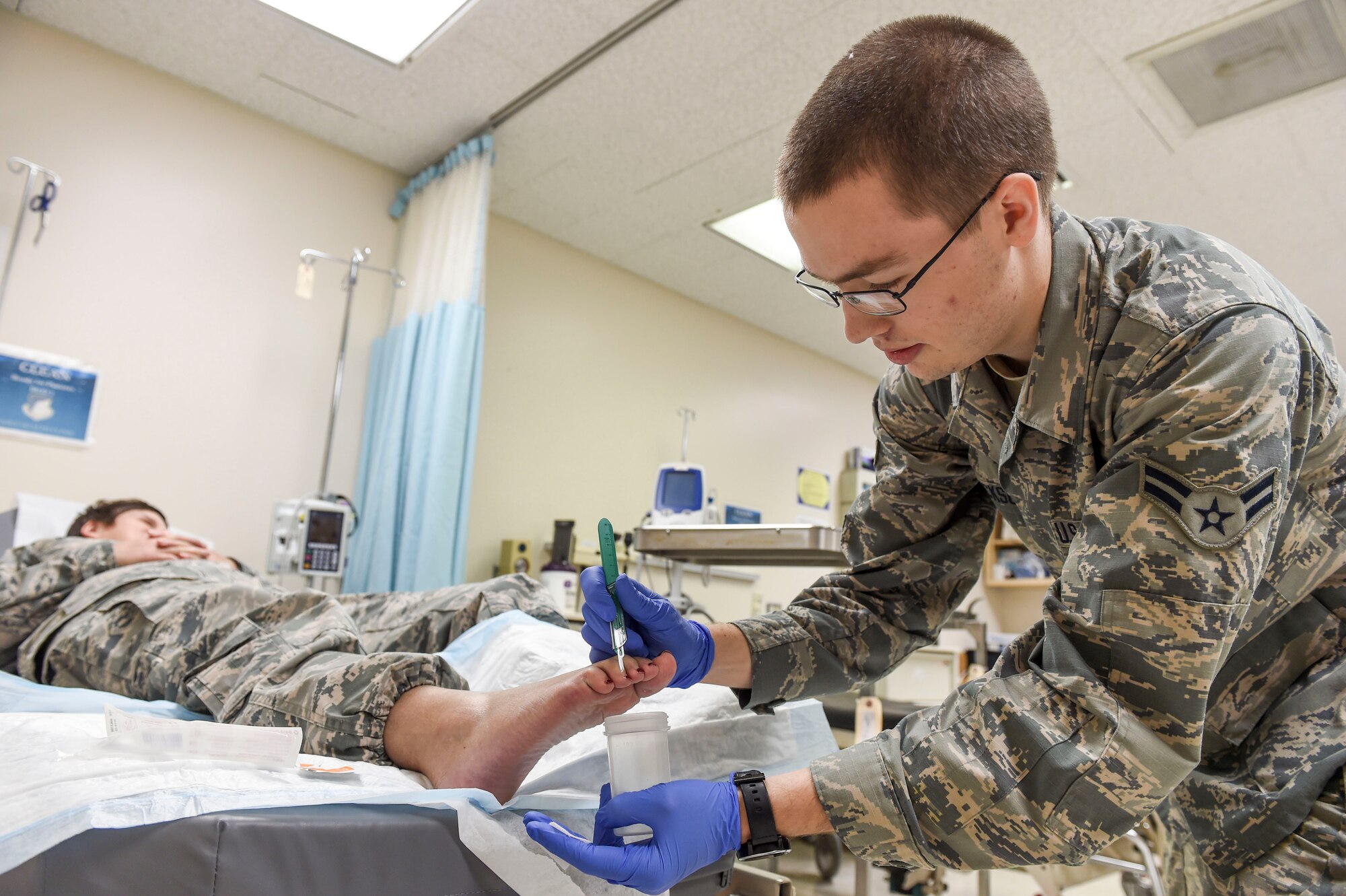 Airman 1st Class JaCoy Erickson, a medical technician with the 59th Medical Wing, retrieves a sample from a patient’s toenail to test for onychomycosis at the Wilford Hall Ambulatory Surgical Center Family Health Clinic on Joint Base San Antonio-Lackland, Texas, Nov. 10, 2016. Onychomycosis is nail fungal infection that occurs in 10 percent of the general population; its symptoms are usually cosmetic, but the infection can lead to serious health complications for certain high-risks groups. (U.S. Air Force photo/Staff Sgt. Michael Ellis)