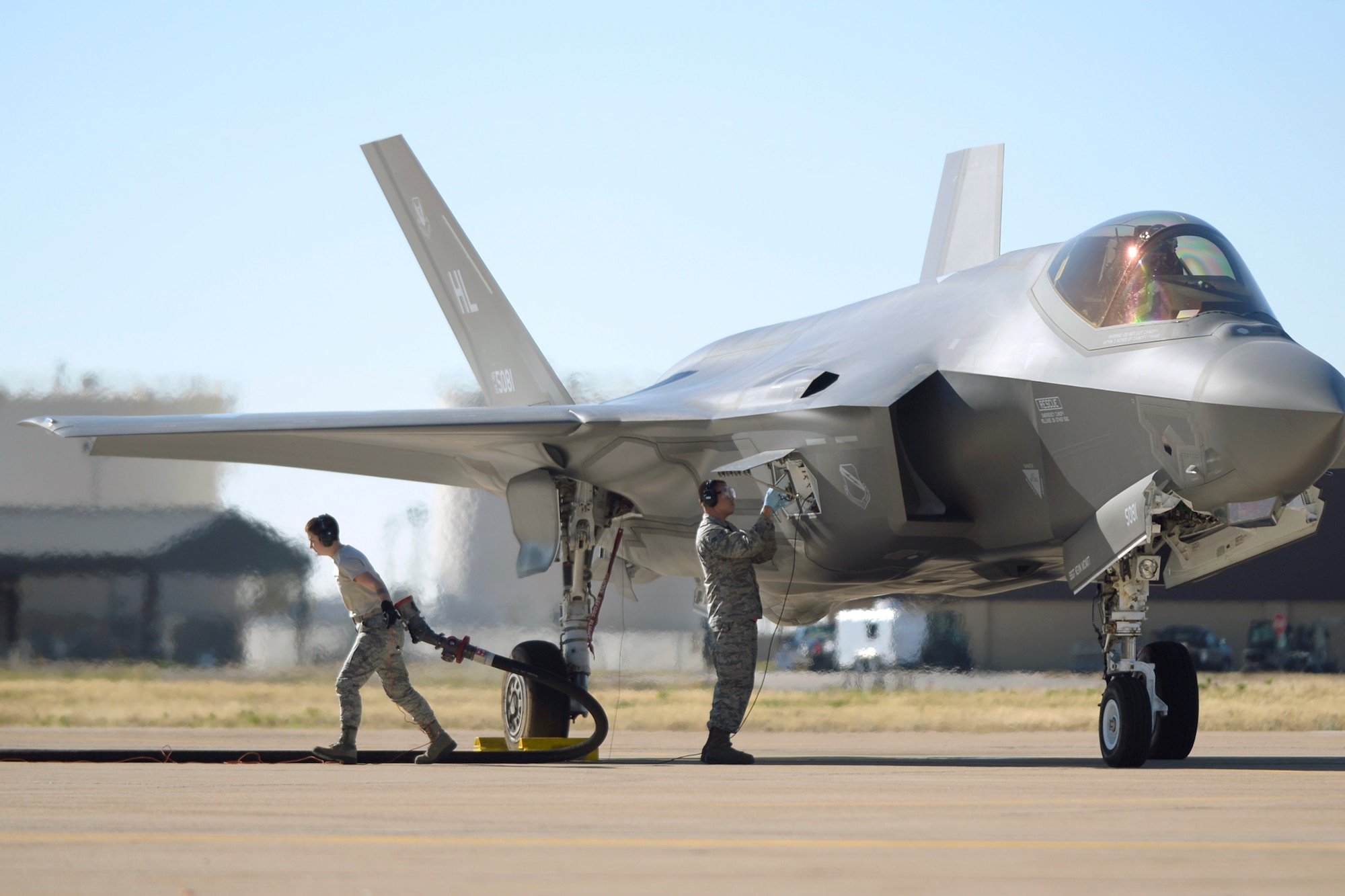 Airmen assigned to the 34th Aircraft Maintenance Unit and 75th Logistics Readiness Squadron perform hot refueling operations on an F-35 Lightning II fighter jet Nov. 8 at Hill Air Force Base. Airmen train on hot pits to increase aircraft availability and provide operators more training opportunities to hone their war-fighting abilities. (U.S. Air Force photo by Todd Cromar)