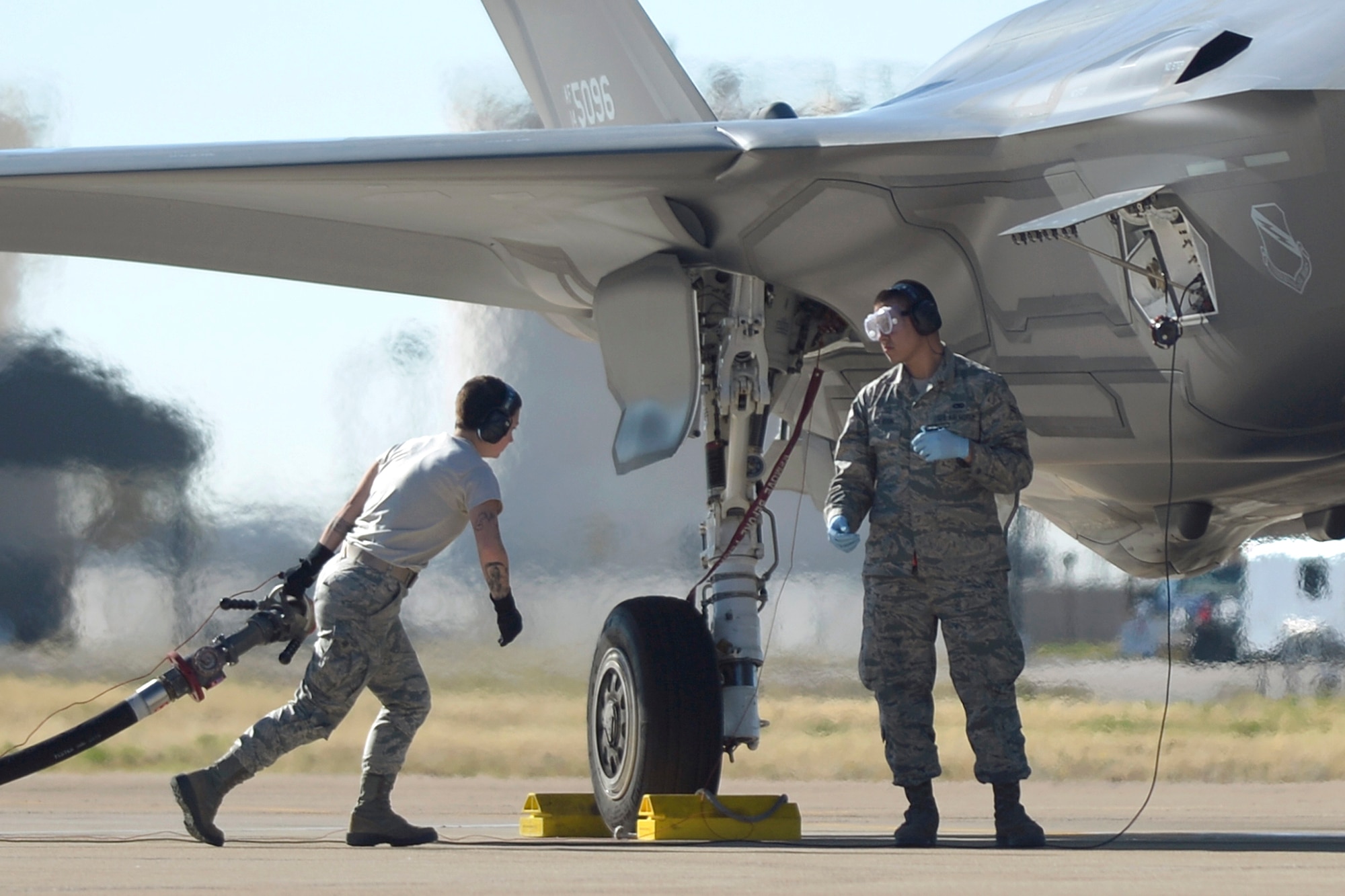 Airmen assigned to the 34th Aircraft Maintenance Unit and 75th Logistics Readiness Squadron perform hot refueling operations on an F-35 Lightning II fighter jet Nov. 8 at Hill Air Force Base. F-35s are flown and maintained by Hill Airmen assigned to the active-duty 388th Fighter Wing and its Reserve component 419th Fighter Wing. (U.S. Air Force photo by Todd Cromar)