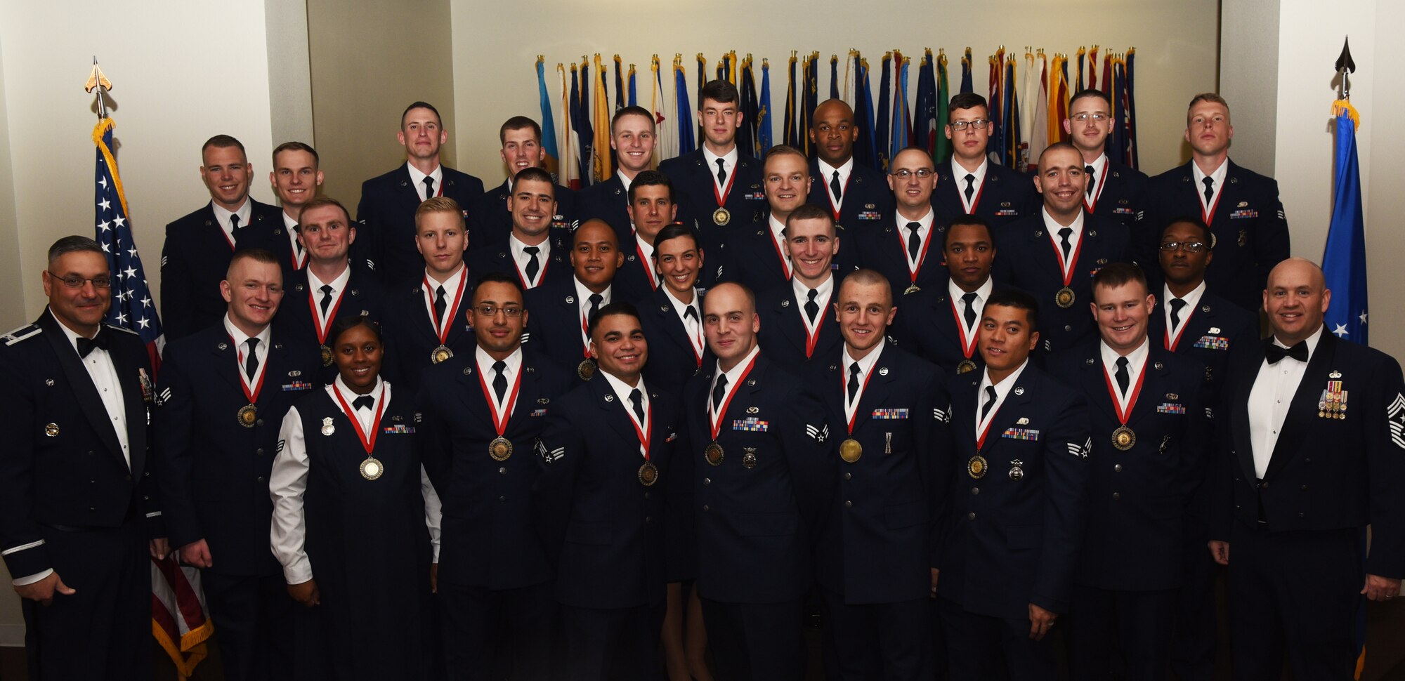 Col. Stephen Kravitsky, 90th Missile Wing commander and Chief Master Sgt. Jeffery Steagall, 90th Missile Wing command chief, pose with the graduating Airman Leadership School Class 17-A students at F.E. Warren Air Force Base, Wyo., Nov. 9, 2016. Enlisted Airmen must complete the rigorous professional military education course to become supervisors of other Airmen. (U.S. Air Force photo by Airman 1st Class Breanna Carter)