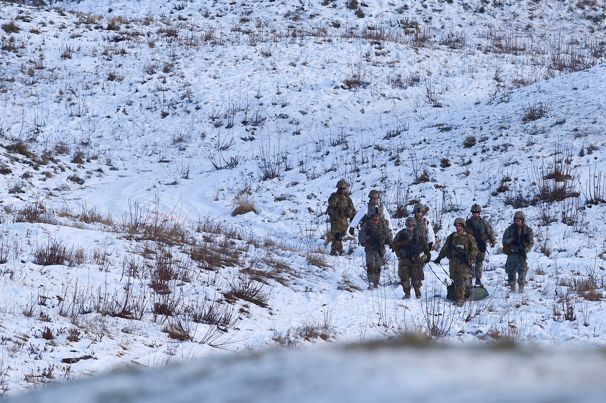 Paratroopers assigned to Baker Company, 3rd Battalion, 509th Parachute Infantry Regiment, 4th Infantry Brigade Combat Team (Airborne), 25th Infantry Division, U.S. Army Alaska, evacuate a simulated casualty during live-fire and movement-to-contact operations on the Infantry Squad Battle Course at Joint Base Elmendorf-Richardson, Alaska, Nov. 8, 2016. The soldiers focused on core infantry skills such as fire team movement, communication, shifting fire, and once on the objective identifying and eliminating weapons caches and treating and evacuating casualties.