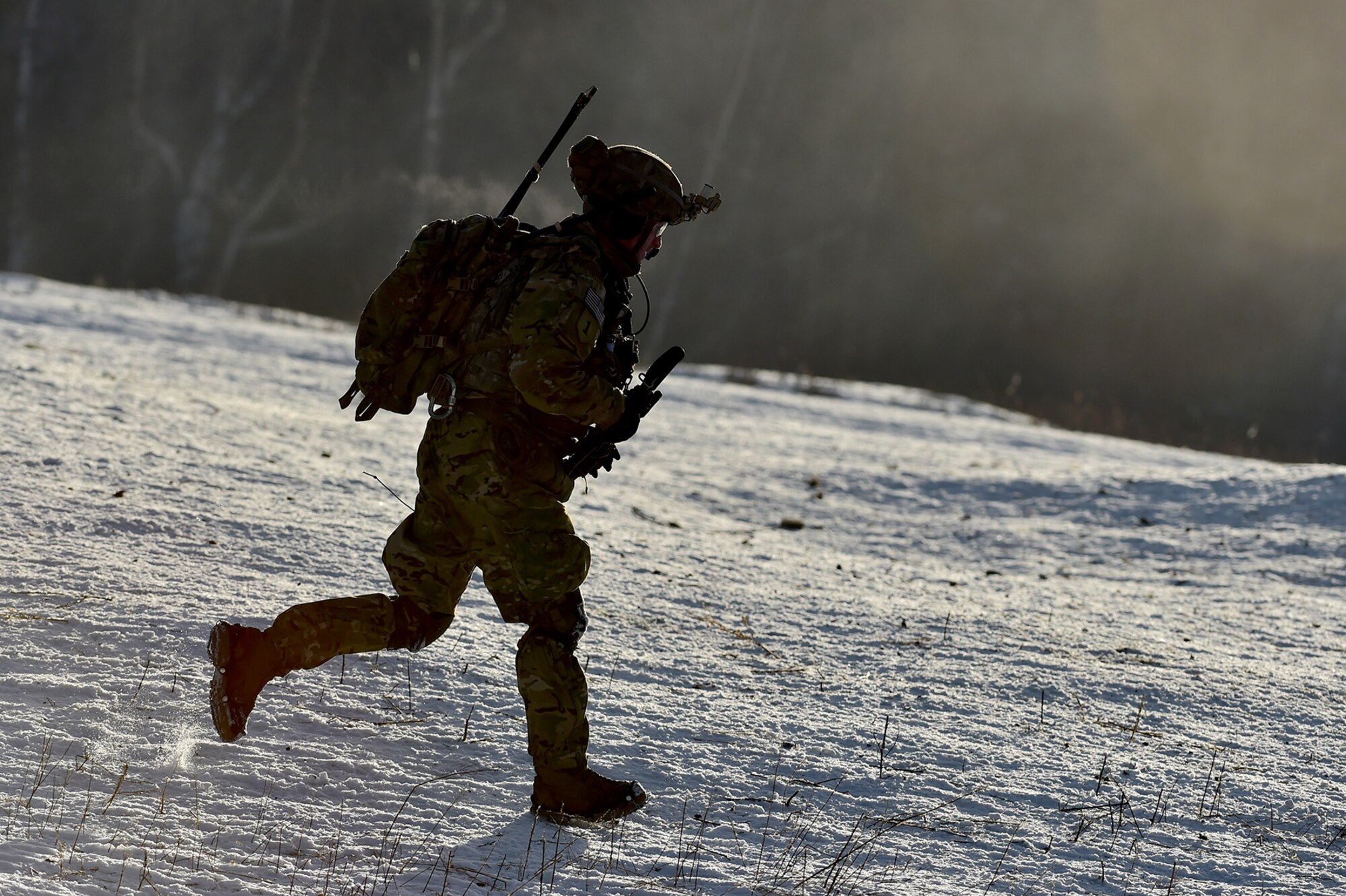 A paratrooper assigned to Baker Company, 3rd Battalion, 509th Parachute Infantry Regiment, 4th Infantry Brigade Combat Team (Airborne), 25th Infantry Division, U.S. Army Alaska, runs behind the line of advance during live-fire and movement-to-contact operations on the Infantry Squad Battle Course at Joint Base Elmendorf-Richardson, Alaska, Nov. 8, 2016. The soldiers focused on core infantry skills such as fire team movement, communication, shifting fire, and once on the objective identifying and eliminating weapons caches and treating and evacuating casualties. 