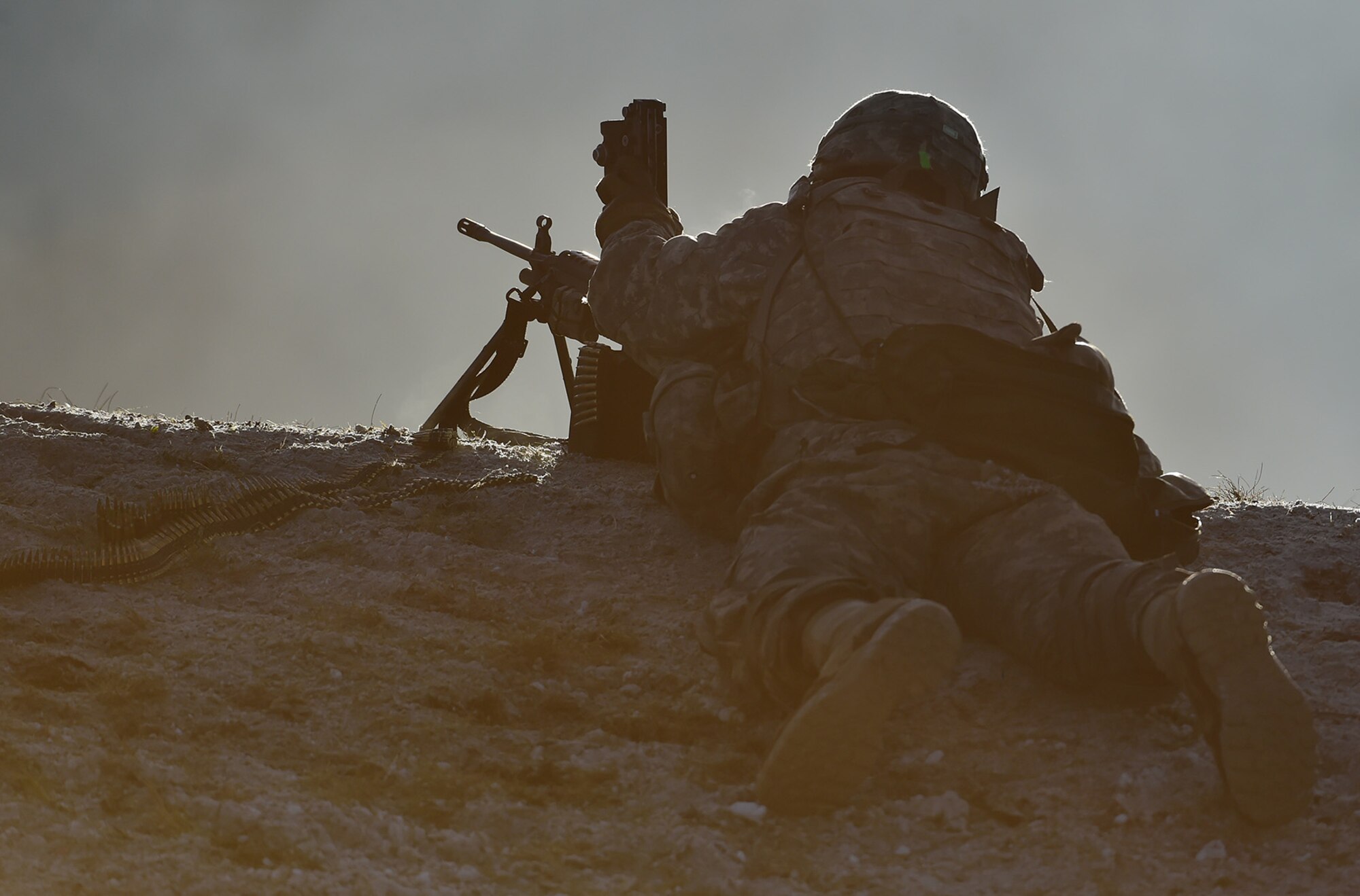 An automatic rifleman assigned to Baker Company, 3rd Battalion, 509th Parachute Infantry Regiment, 4th Infantry Brigade Combat Team (Airborne), 25th Infantry Division, U.S. Army Alaska, reloads his M249 Squad Automatic Weapon during live-fire and movement-to-contact operations on the Infantry Squad Battle Course at Joint Base Elmendorf-Richardson, Alaska, Nov. 8, 2016. The soldiers focused on core infantry skills such as fire team movement, communication, shifting fire, and once on the objective identifying and eliminating weapons caches and treating and evacuating casualties. 