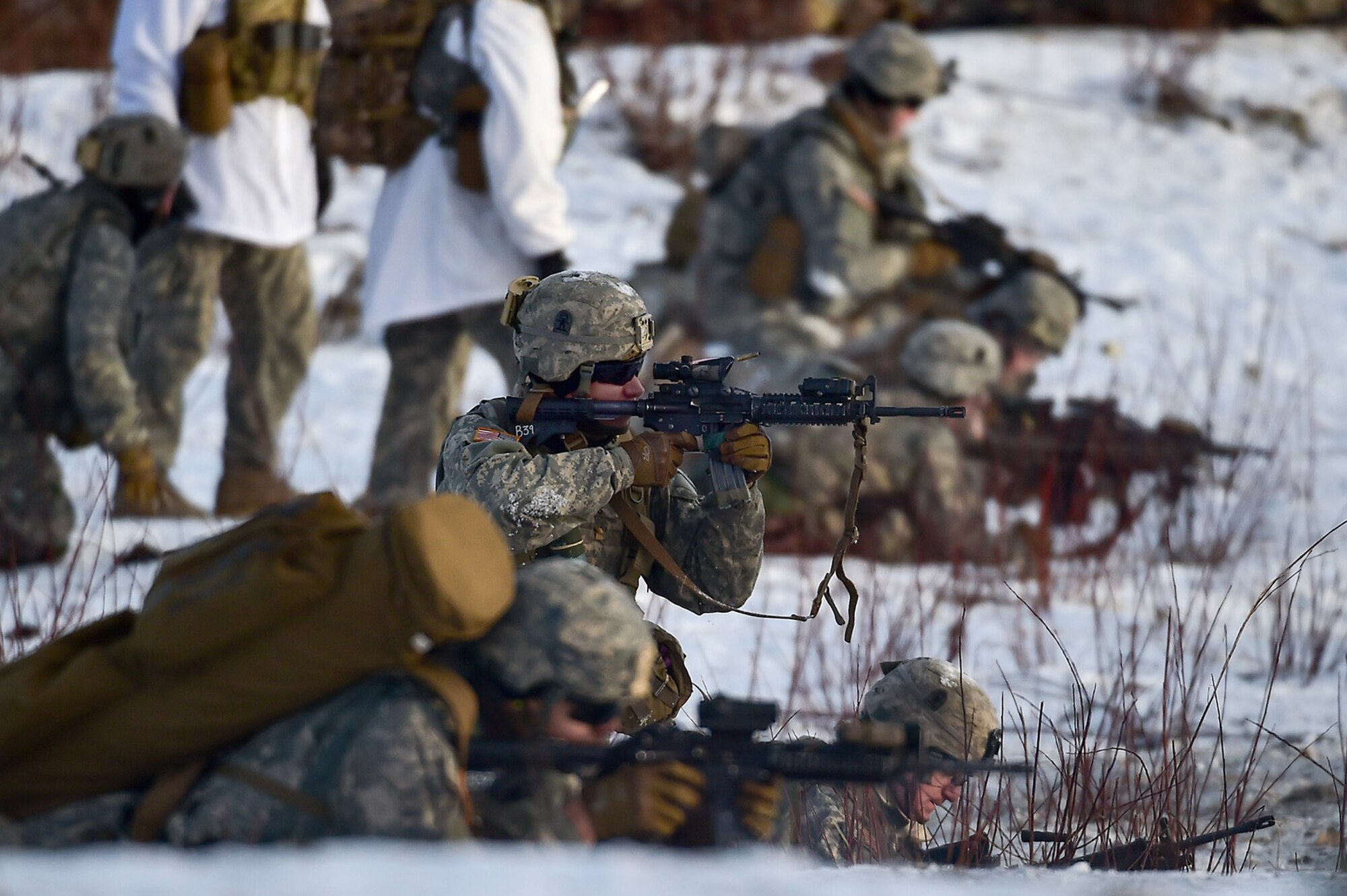 A paratrooper assigned to Baker Company, 3rd Battalion, 509th Parachute Infantry Regiment, 4th Infantry Brigade Combat Team (Airborne), 25th Infantry Division, U.S. Army Alaska, fires his M4 carbine during live-fire and movement-to-contact operations on the Infantry Squad Battle Course at Joint Base Elmendorf-Richardson, Alaska, Nov. 8, 2016. The soldiers focused on core infantry skills such as fire team movement, communication, shifting fire, and once on the objective identifying and eliminating weapons caches and treating and evacuating casualties.