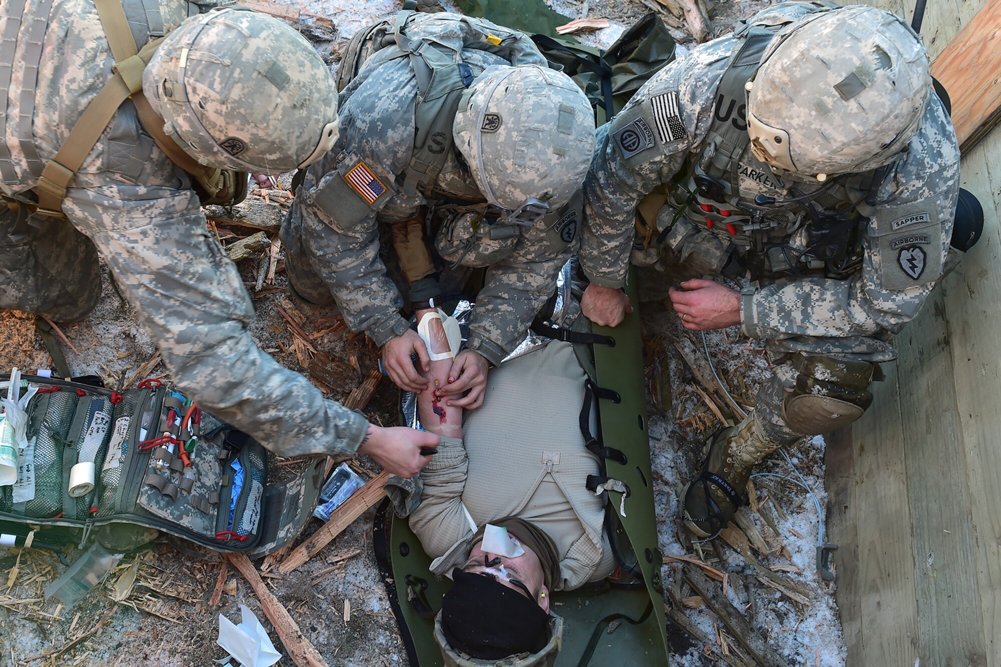 Paratroopers assigned to Baker Company, 3rd Battalion, 509th Parachute Infantry Regiment, 4th Infantry Brigade Combat Team (Airborne), 25th Infantry Division, U.S. Army Alaska, provide medical treatment to a simulated casualty during live-fire and movement-to-contact operations on the Infantry Squad Battle Course at Joint Base Elmendorf-Richardson, Alaska, Nov. 8, 2016. The soldiers focused on core infantry skills such as fire team movement, communication, shifting fire, and once on the objective identifying and eliminating weapons caches and treating and evacuating casualties.  