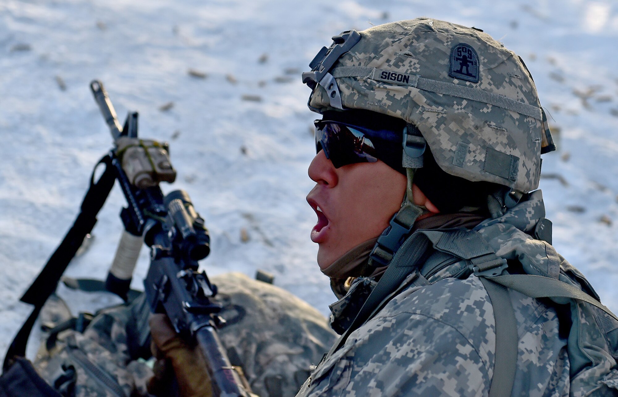 Army Pfc. Chrisalexander Sison, assigned to Baker Company, 3rd Battalion, 509th Parachute Infantry Regiment, 4th Infantry Brigade Combat Team (Airborne), 25th Infantry Division, U.S. Army Alaska, yells to a fellow paratrooper during live-fire and movement-to-contact operations on the Infantry Squad Battle Course at Joint Base Elmendorf-Richardson, Alaska, Nov. 8, 2016. The soldiers focused on core infantry skills such as fire team movement, communication, shifting fire, and once on the objective identifying and eliminating weapons caches and treating and evacuating casualties. 