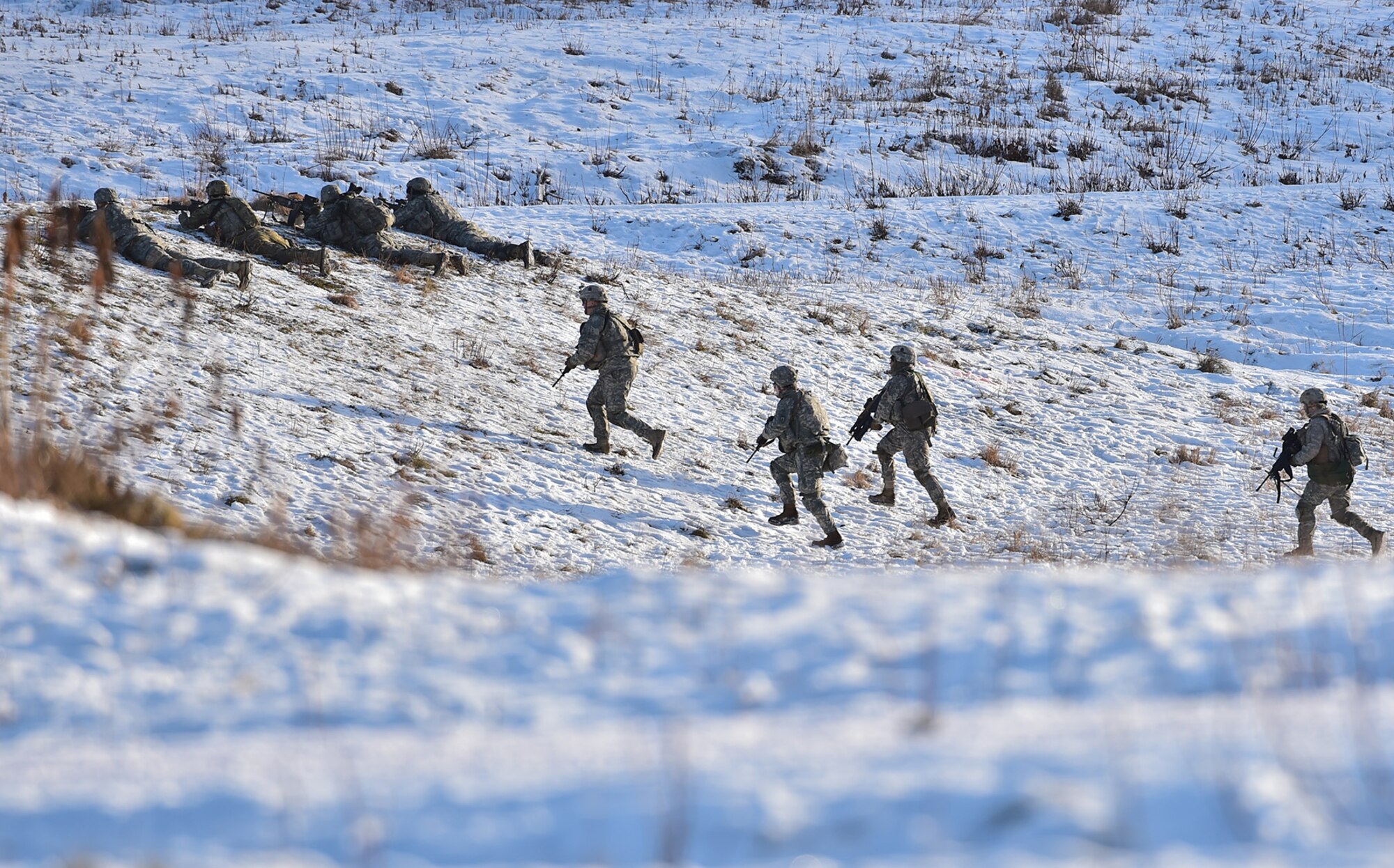 Paratroopers assigned to Baker Company, 3rd Battalion, 509th Parachute Infantry Regiment, 4th Infantry Brigade Combat Team (Airborne), 25th Infantry Division, U.S. Army Alaska, advance while conducting live-fire and movement-to-contact operations on the Infantry Squad Battle Course at Joint Base Elmendorf-Richardson, Alaska, Nov. 8, 2016. The soldiers focused on core infantry skills such as fire team movement, communication, shifting fire, and once on the objective identifying and eliminating weapons caches and treating and evacuating casualties. 