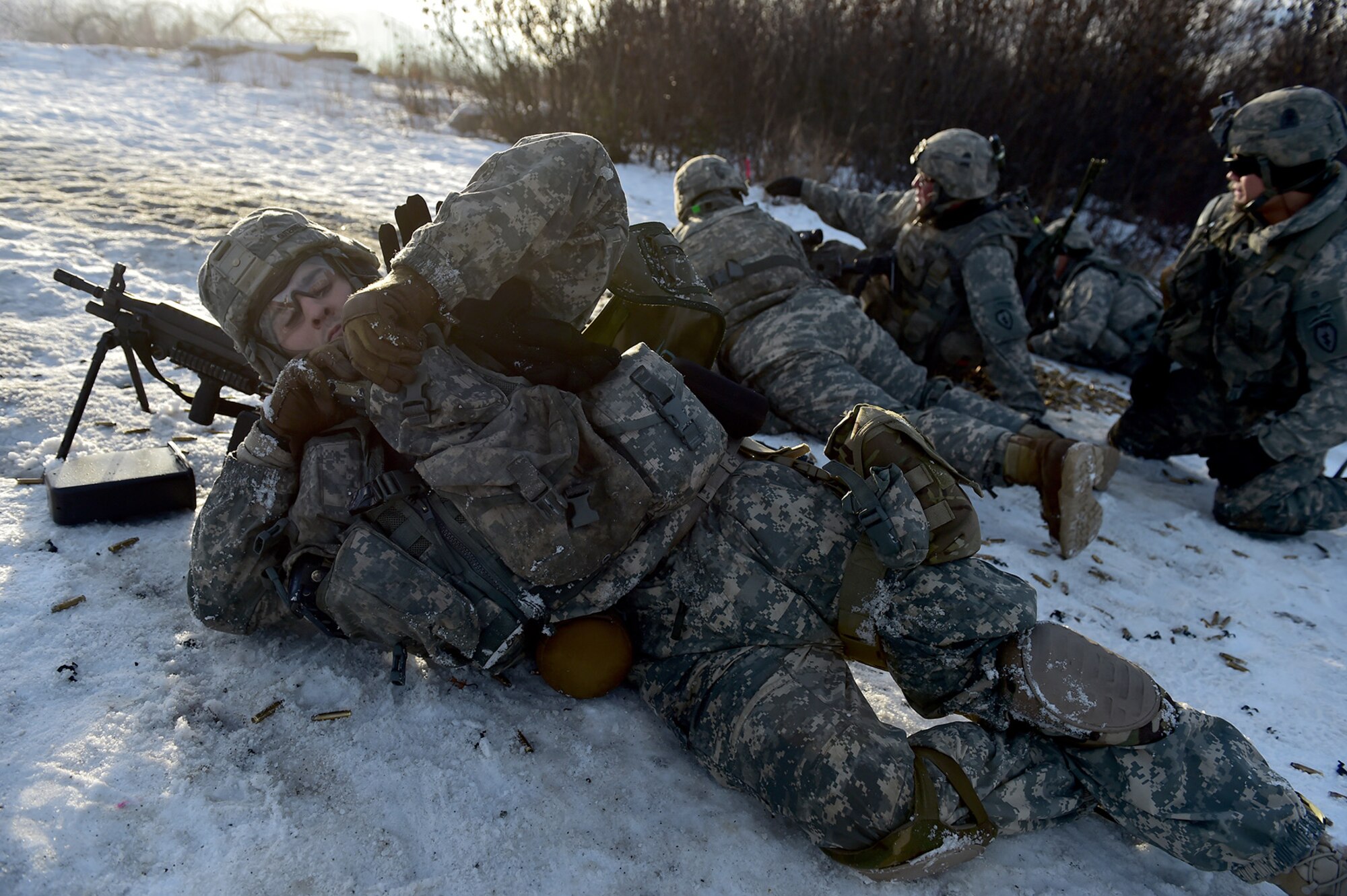 Spc. Daniel Gutierrez, assigned to Baker Company, 3rd Battalion, 509th Parachute Infantry Regiment, 4th Infantry Brigade Combat Team (Airborne), 25th Infantry Division, U.S. Army Alaska, secures his equipment before advancing during live-fire and movement-to-contact operations on the Infantry Squad Battle Course at Joint Base Elmendorf-Richardson, Alaska, Nov. 8, 2016. The soldiers focused on core infantry skills such as fire team movement, communication, shifting fire, and once on the objective identifying and eliminating weapons caches and treating and evacuating casualties. 