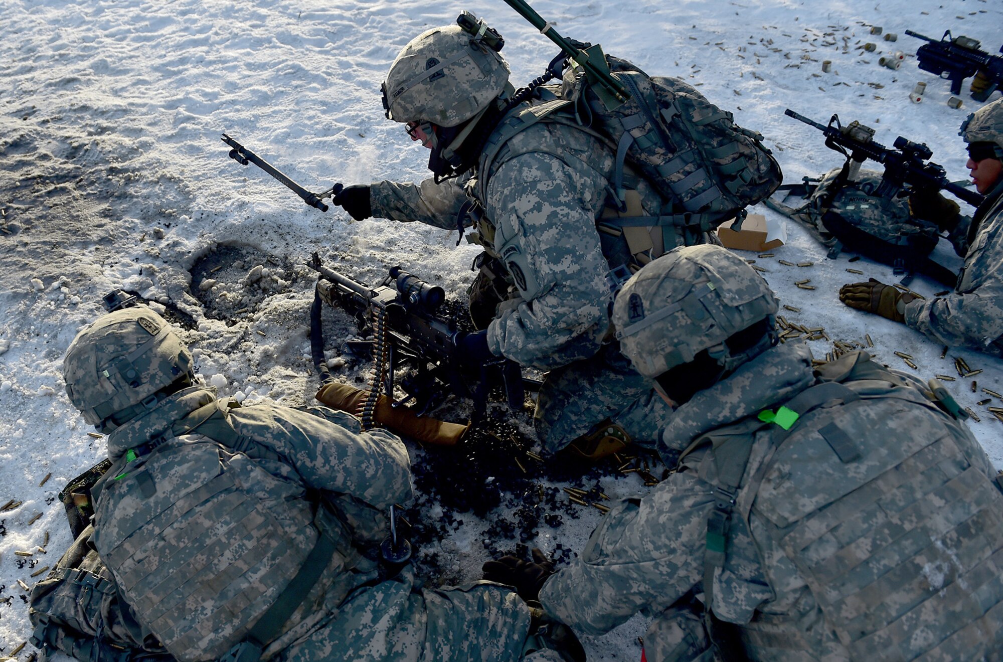 Paratroopers assigned to Baker Company, 3rd Battalion, 509th Parachute Infantry Regiment, 4th Infantry Brigade Combat Team (Airborne), 25th Infantry Division, U.S. Army Alaska, switch out barrels of a machine gun during live-fire and movement-to-contact operations on the Infantry Squad Battle Course at Joint Base Elmendorf-Richardson, Alaska, Nov. 8, 2016. The soldiers focused on core infantry skills such as fire team movement, communication, shifting fire, and once on the objective identifying and eliminating weapons caches and treating and evacuating casualties. 