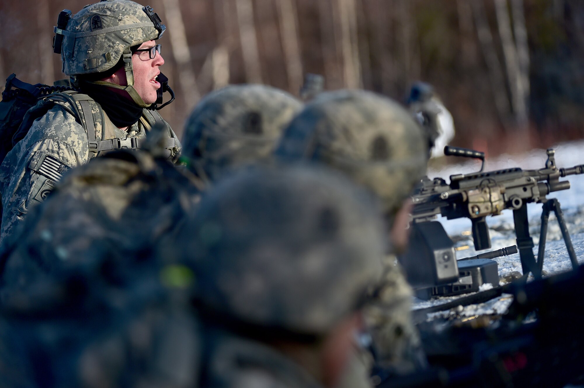Army Staff Sgt. Samuel Hammer, assigned to Baker Company, 3rd Battalion, 509th Parachute Infantry Regiment, 4th Infantry Brigade Combat Team (Airborne), 25th Infantry Division, U.S. Army Alaska, watches fellow paratroopers advance during live-fire and movement-to-contact operations on the Infantry Squad Battle Course at Joint Base Elmendorf-Richardson, Alaska, Nov. 8, 2016. The soldiers focused on core infantry skills such as fire team movement, communication, shifting fire, and once on the objective identifying and eliminating weapons caches and treating and evacuating casualties. 