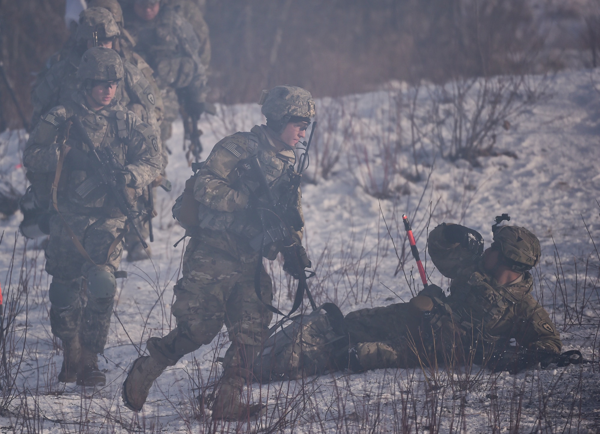 Army 2nd Lt. Andrew Biermann, assigned to Baker Company, 3rd Battalion, 509th Parachute Infantry Regiment, 4th Infantry Brigade Combat Team (Airborne), 25th Infantry Division, U.S. Army Alaska, leads his Soldiers through a breach point during live-fire and movement-to-contact operations on the Infantry Squad Battle Course at Joint Base Elmendorf-Richardson, Alaska, Nov. 8, 2016. The soldiers focused on core infantry skills such as fire team movement, communication, shifting fire, and once on the objective identifying and eliminating weapons caches and treating and evacuating casualties.  