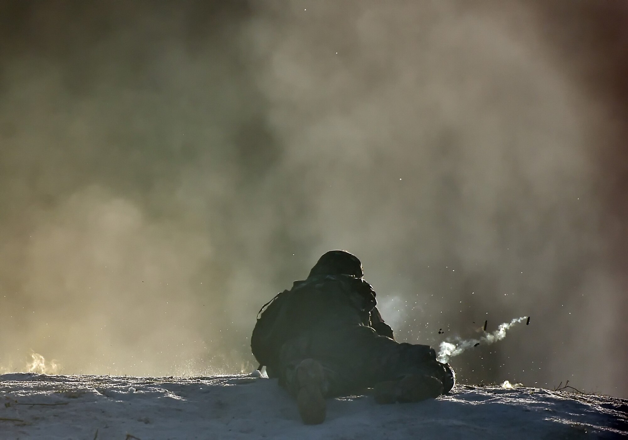 A paratrooper assigned to Baker Company, 3rd Battalion, 509th Parachute Infantry Regiment, 4th Infantry Brigade Combat Team (Airborne), 25th Infantry Division, U.S. Army Alaska, fires his weapon through a thick cover of smoke during live-fire and movement-to-contact operations on the Infantry Squad Battle Course at Joint Base Elmendorf-Richardson, Alaska, Nov. 8, 2016. The soldiers focused on core infantry skills such as fire team movement, communication, shifting fire, and once on the objective identifying and eliminating weapons caches and treating and evacuating casualties.  