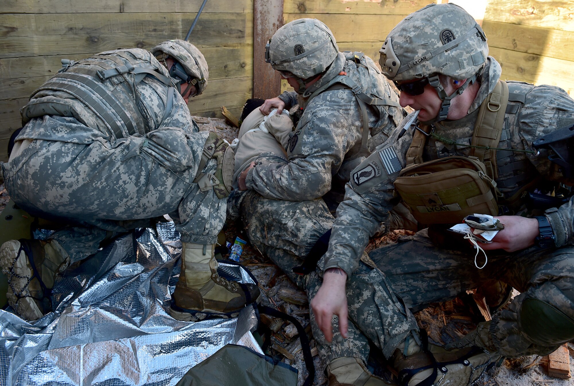 Paratroopers assigned to Baker Company, 3rd Battalion, 509th Parachute Infantry Regiment, 4th Infantry Brigade Combat Team (Airborne), 25th Infantry Division, U.S. Army Alaska, perform medical treatment to a simulated casualty during live-fire and movement-to-contact operations on the Infantry Squad Battle Course at Joint Base Elmendorf-Richardson, Alaska, Nov. 8, 2016. The soldiers focused on core infantry skills such as fire team movement, communication, shifting fire, and once on the objective identifying and eliminating weapons caches and treating and evacuating casualties. 