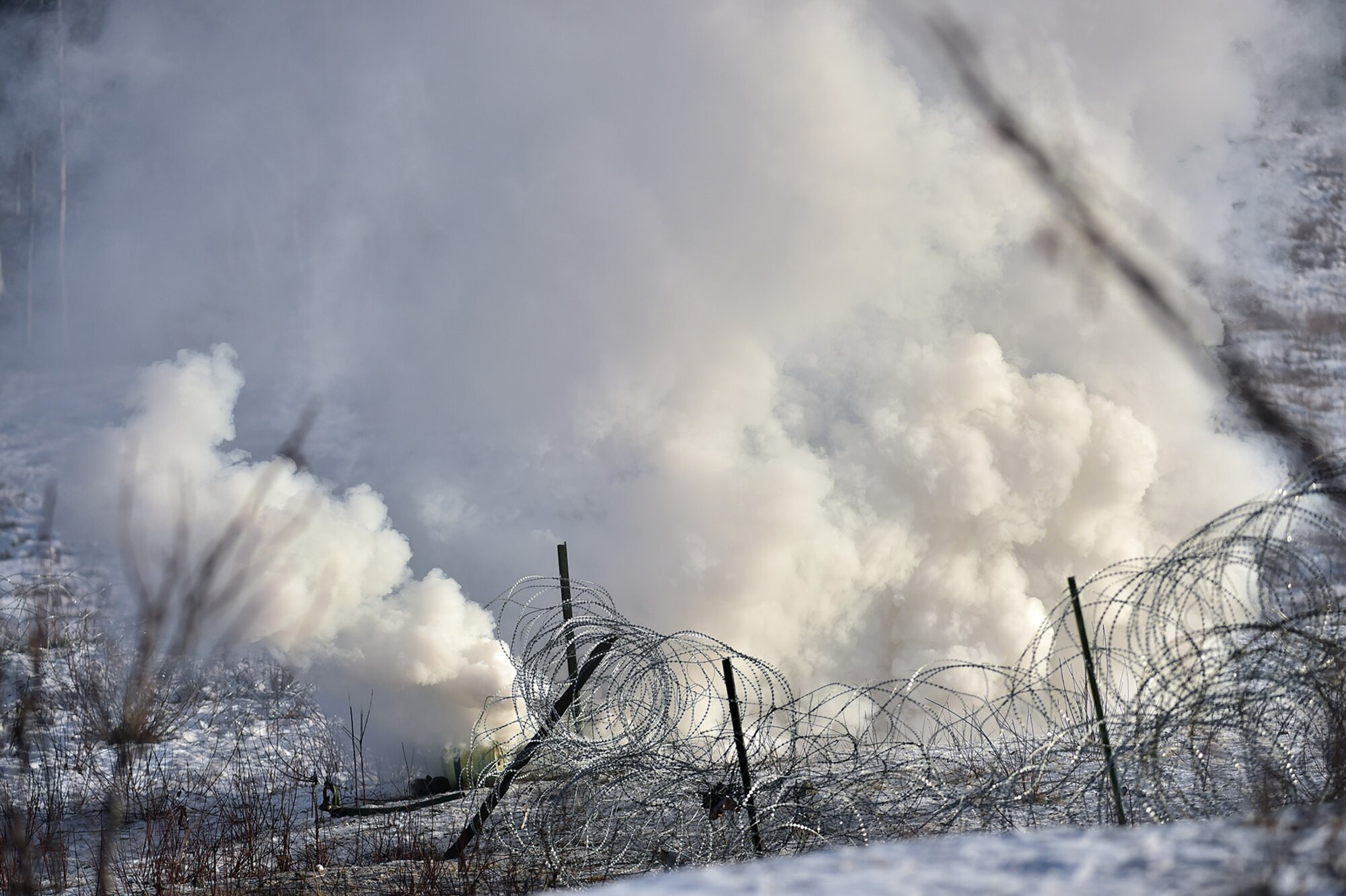 Paratroopers assigned to Baker Company, 3rd Battalion, 509th Parachute Infantry Regiment, 4th Infantry Brigade Combat Team (Airborne), 25th Infantry Division, U.S. Army Alaska, breach a wire obstacle during live-fire and movement-to-contact operations on the Infantry Squad Battle Course at Joint Base Elmendorf-Richardson, Alaska, Nov. 8, 2016. The soldiers focused on core infantry skills such as fire team movement, communication, shifting fire, and once on the objective identifying and eliminating weapons caches and treating and evacuating casualties.