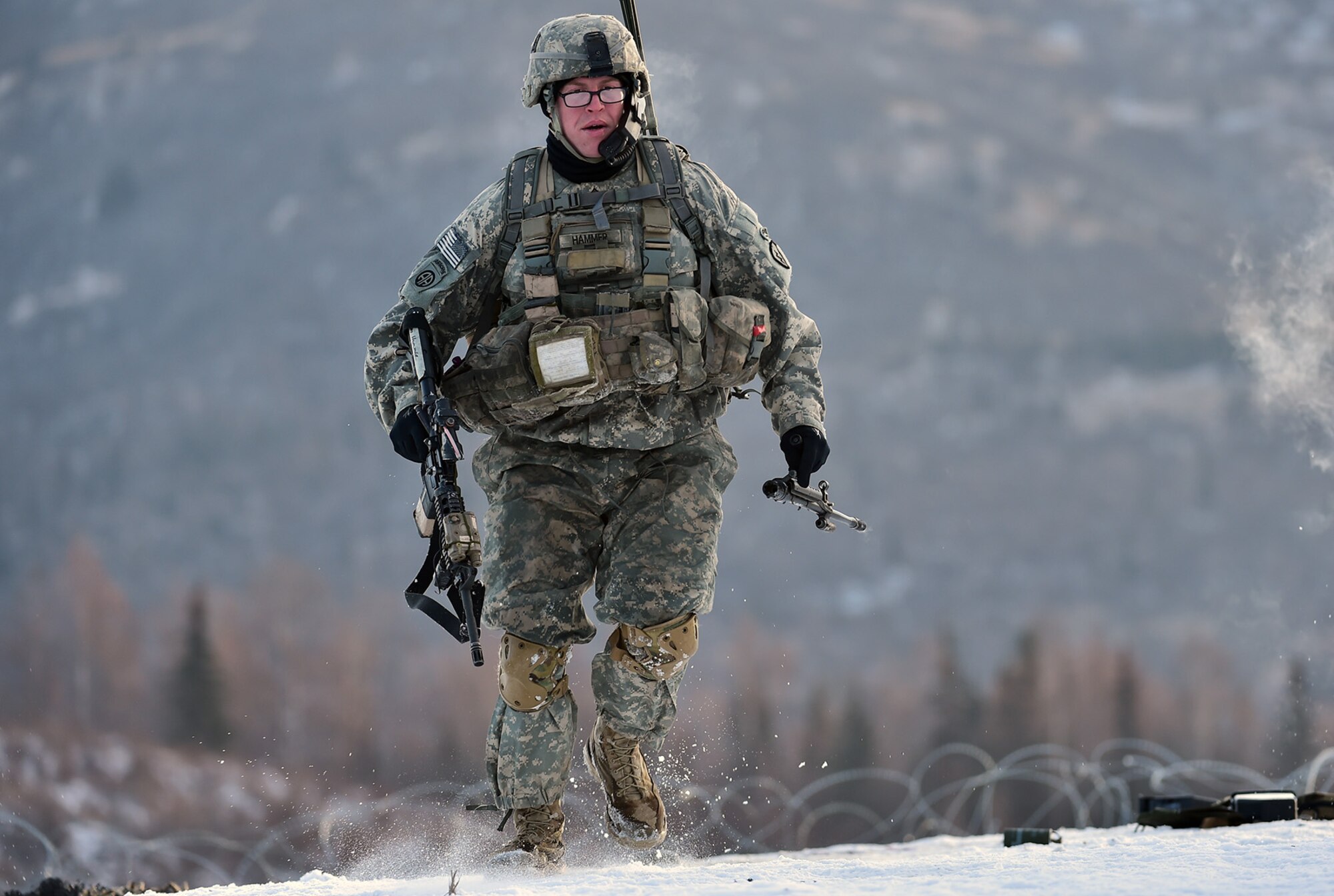 Army Staff Sgt. Samuel Hammer, assigned to Baker Company, 3rd Battalion, 509th Parachute Infantry Regiment, 4th Infantry Brigade Combat Team (Airborne), 25th Infantry Division, U.S. Army Alaska, pulls back from a firing line before fellow paratroopers beach an obstacle during live-fire and movement-to-contact operations on the Infantry Squad Battle Course at Joint Base Elmendorf-Richardson, Alaska, Nov. 8, 2016. The soldiers focused on core infantry skills such as fire team movement, communication, shifting fire, and once on the objective identifying and eliminating weapons caches and treating and evacuating casualties.  