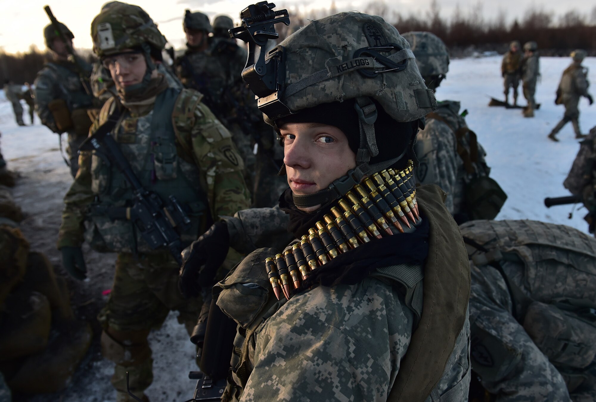 Spc. Scott Kellogg, assigned to Baker Company, 3rd Battalion, 509th Parachute Infantry Regiment, 4th Infantry Brigade Combat Team (Airborne), 25th Infantry Division, U.S. Army Alaska, links up with fellow paratroopers waiting for an after-action briefing after live-fire and movement-to-contact operations on the Infantry Squad Battle Course at Joint Base Elmendorf-Richardson, Alaska, Nov. 8, 2016. The soldiers focused on core infantry skills such as fire team movement, communication, shifting fire, and once on the objective identifying and eliminating weapons caches and treating and evacuating casualties.  (U.S. Air Force photo/Justin Connaher)