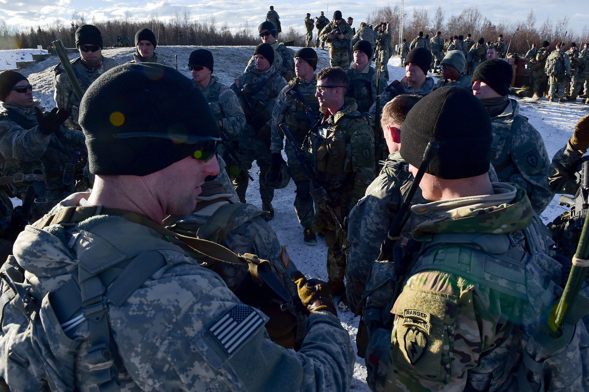 Paratroopers assigned to Baker Company, 3rd Battalion, 509th Parachute Infantry Regiment, 4th Infantry Brigade Combat Team (Airborne), 25th Infantry Division, U.S. Army Alaska, gather for an after-action briefing after conducting live-fire and movement-to-contact operations on the Infantry Squad Battle Course at Joint Base Elmendorf-Richardson, Alaska, Nov. 8, 2016. The soldiers focused on core infantry skills such as fire team movement, communication, shifting fire, and once on the objective identifying and eliminating weapons caches and treating and evacuating casualties. 