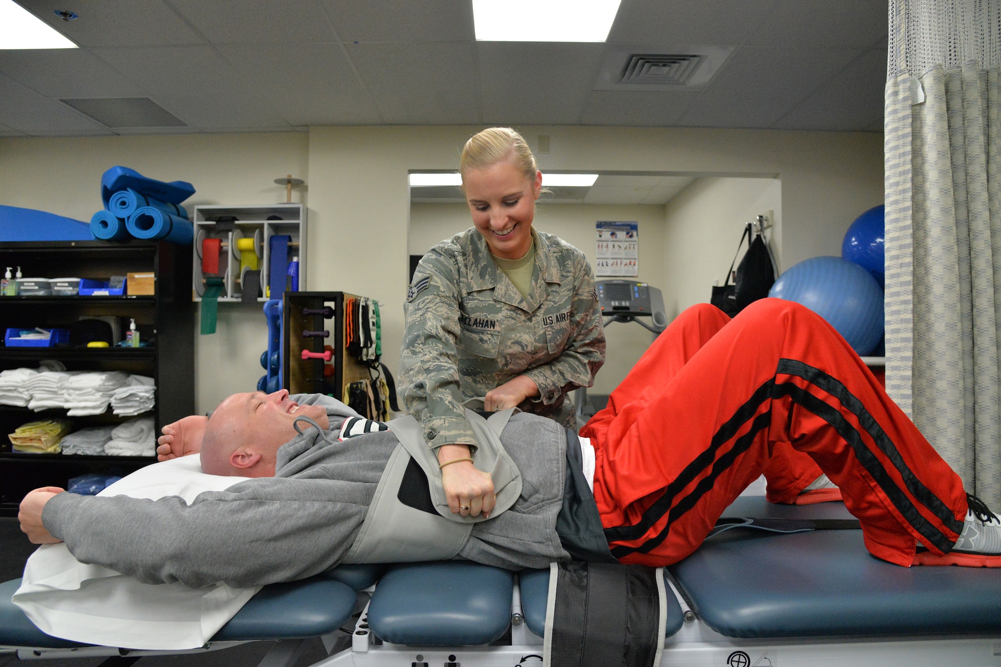 Senior Airman Kaitlyn Callahan, 341st Medical Operations Squadron physical therapy technician, performs traction on Col. Jay Folds, 341st Missile Wing vice commander, Nov. 8, 2016, at Malmstrom Air Force Base, Mont. Traction stretches the spine to assist with pain management. (U.S. Air Force photo/Airman 1st Class Daniel Brosam)