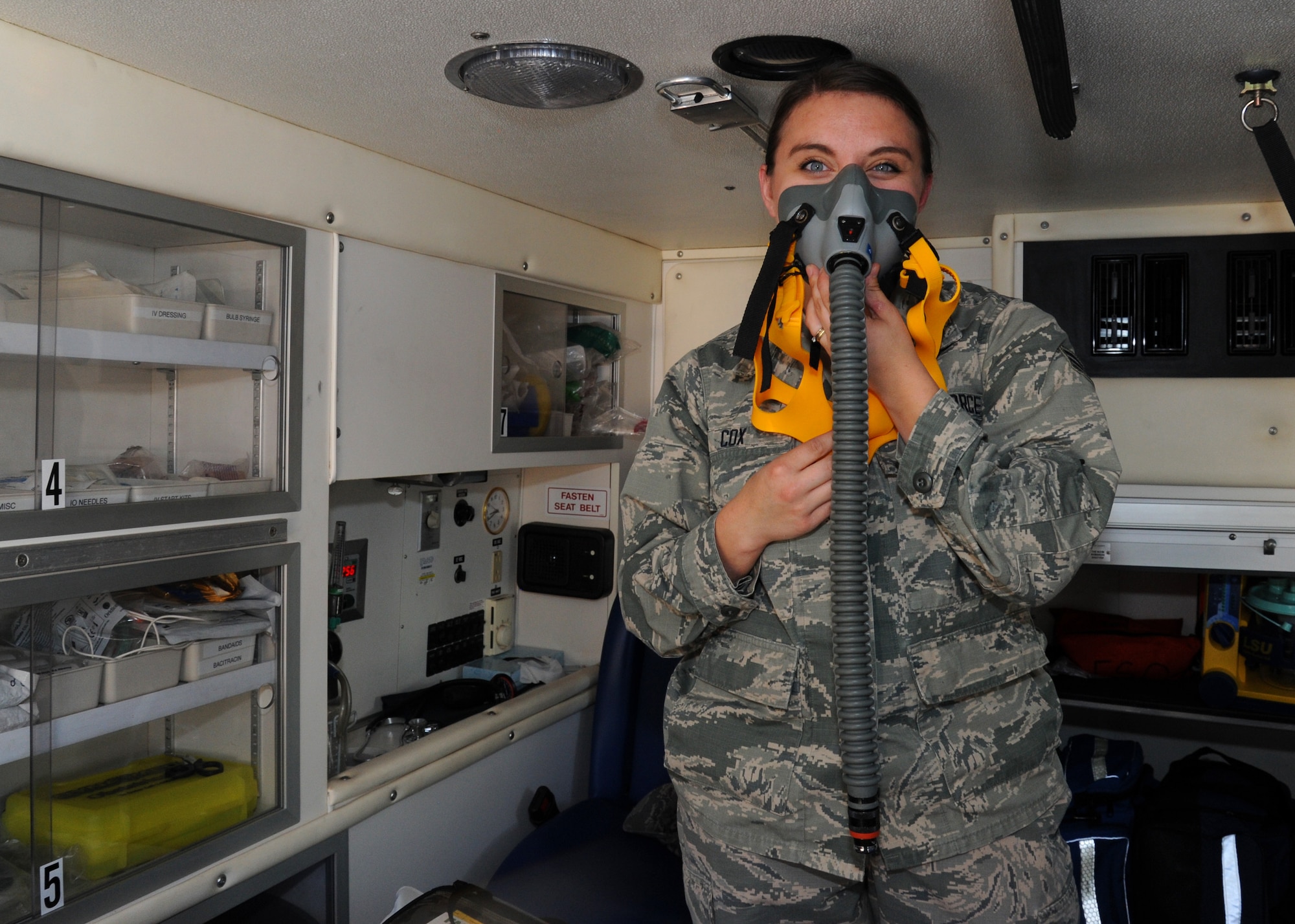 Senior Airman Ashley Cox, 92nd Medical Operations Squadron emergency medical technician, demonstrates how to use an oxygen mask, Aug. 18, 2016, at Fairchild Air Force Base, Wash. Fairchild ambulances are capable of transporting up to four casualties at one time. (U.S. Air Force photo/Senior Airman Samuel Fogleman)