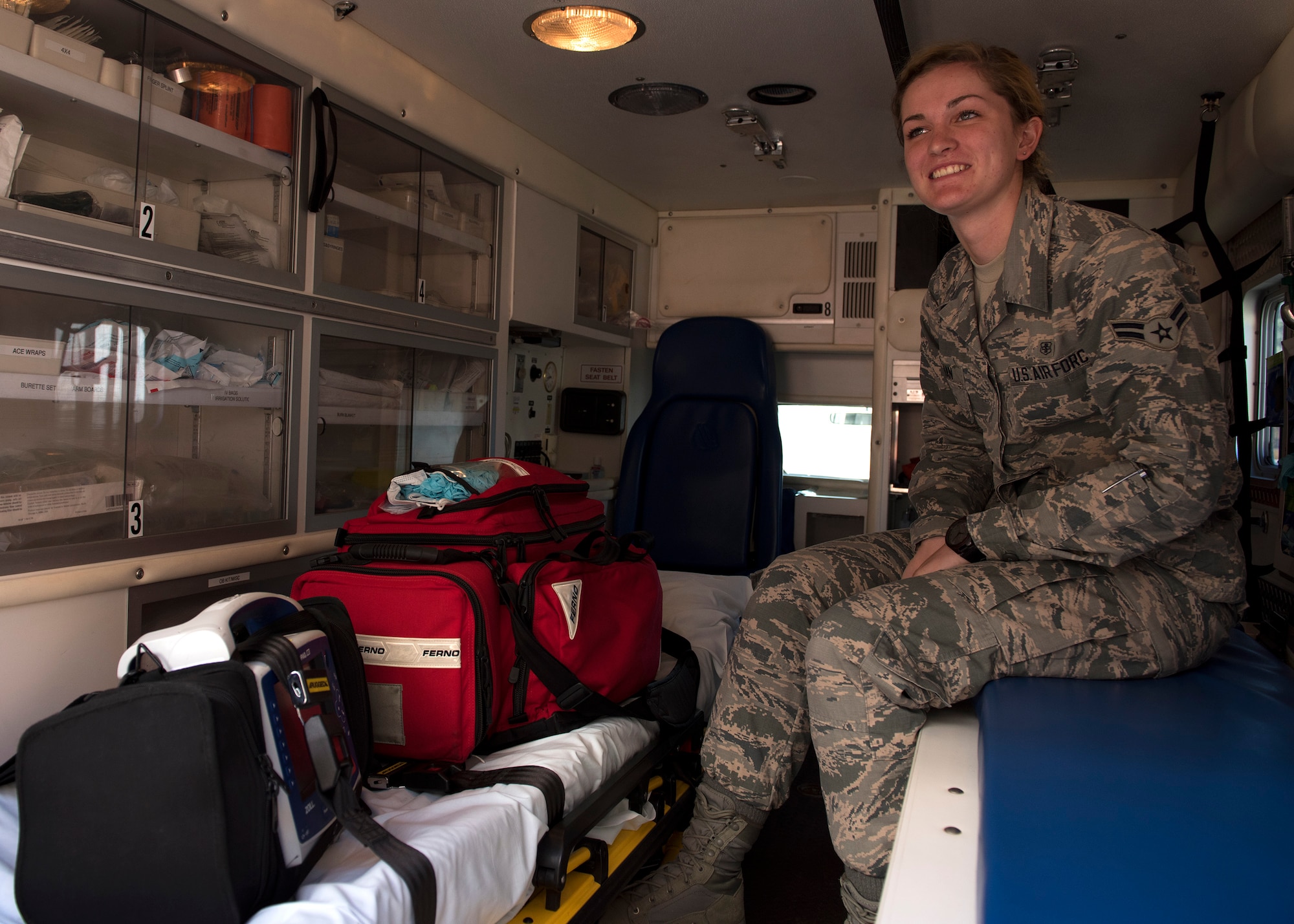 Airman 1st Class Shawn Regina McMahan, 92nd Medical Operations Squadron emergency medical technician, displays a crash kit, defibulator and vitals monitor in the rear compartment of an ambulance, Aug. 18, 2016, at Fairchild Air Force Base, Wash. Fairchild EMTs work 24-hour shifts with two days off in-between. (U.S. Air Force photo/Airman 1st Class Ryan Lackey)