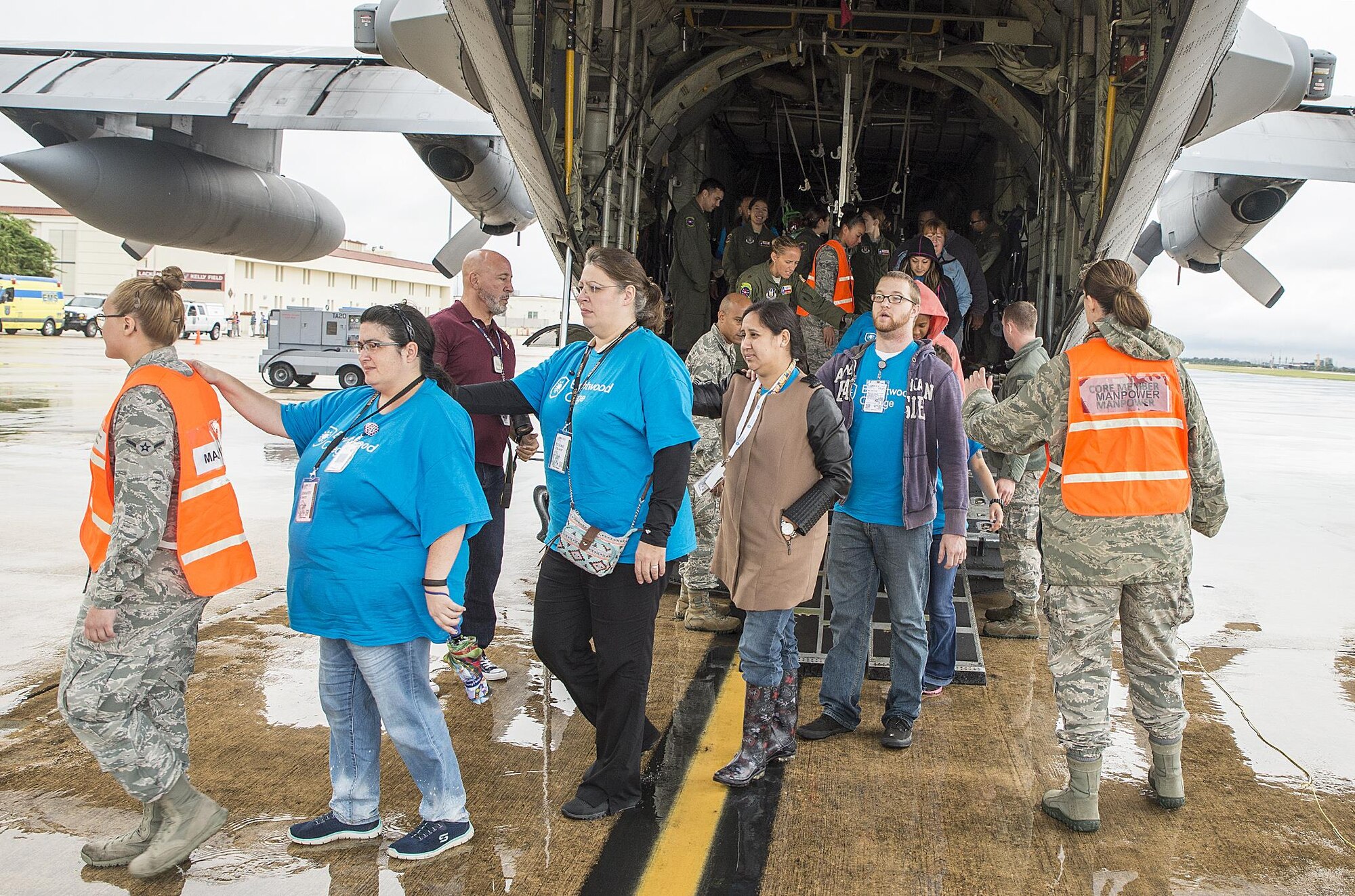 Patients are escorted off of a C-130 Hercules aircraft by Airmen from the 433rd Aeromedical Evacuation Squadron during a natural disaster exercise Nov. 9, 2016 at Joint Base San Antonio-Lackland, Texas.The exercise allowed the South Texas Regional Advisory Council to meet its annual requirement to test its ability to evacuate patients with regional Emergency Medical Service departments. (U.S. Air Force photo by Benjamin Faske)