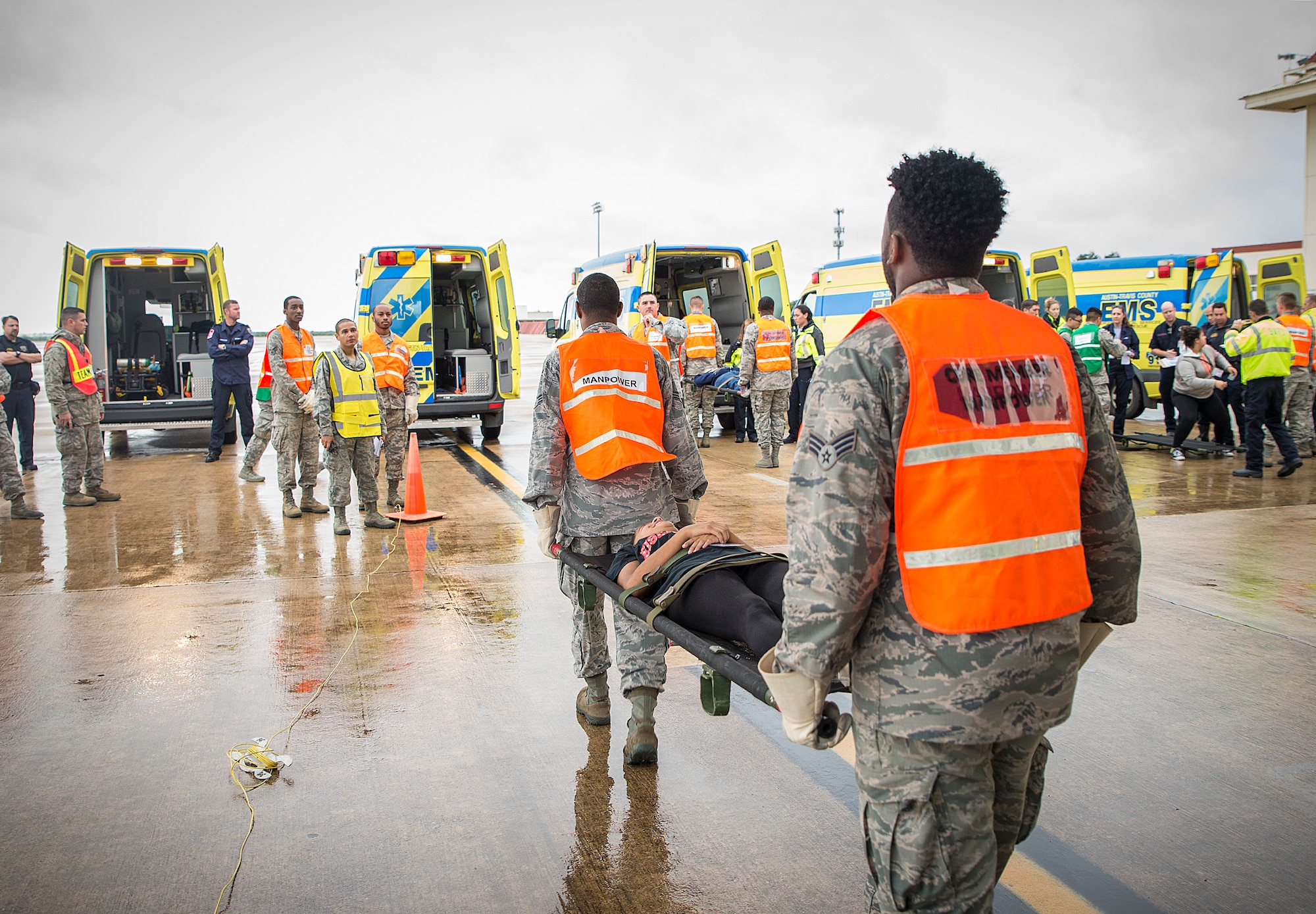 Airmen with the 433rd Aeromedical Evacuation Squadron move littered patients to waiting ambulances during a natural disaster exercise Nov. 9, 2016 at Joint Base San Antonio-Lackland, Texas. The exercise allowed the South Texas Regional Advisory Council to meet its annual requirement to test its ability to evacuate patients with regional Emergency Medical Service departments. (U.S. Air Force photo by Benjamin Faske)