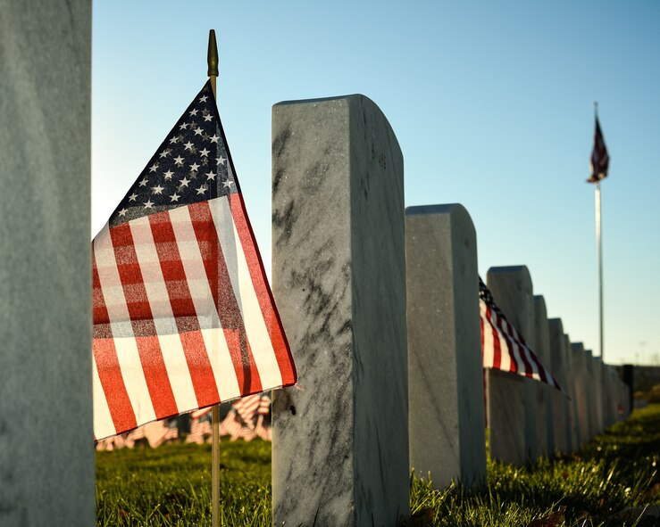 A flag catches early morning light beside a cemetery marker at the Utah Veterans Memorial Cemetery in Bluffdale, Nov. 10. (U.S. Air Force photo by R. Nial Bradshaw)
