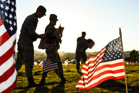 Team Hill Airmen carry flag bundles during a flag-placing detail at the Utah Veterans Memorial Cemetery in Bluffdale, Nov. 10. (U.S. Air Force photo by R. Nial Bradshaw))
