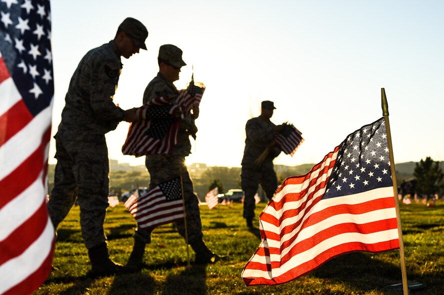 Team Hill Airmen carry flag bundles during a flag-placing detail at the Utah Veterans Memorial Cemetery in Bluffdale, Nov. 10. (U.S. Air Force photo by R. Nial Bradshaw))
