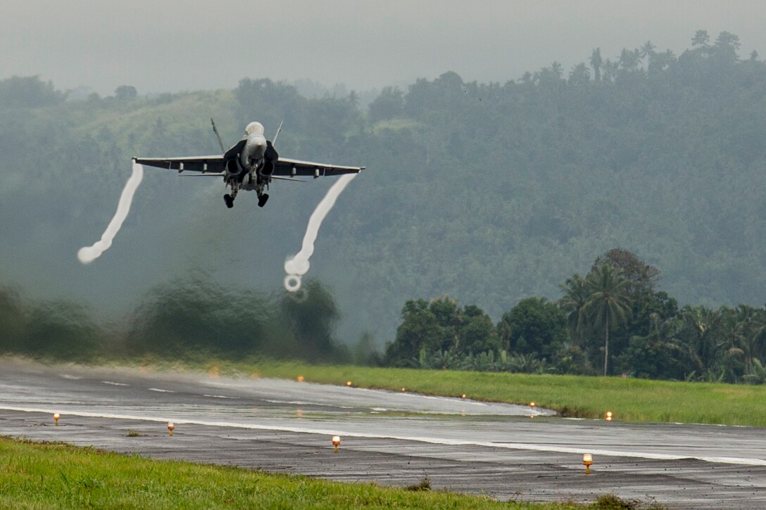 A U.S. Marine Corps F/A-18D Hornet with Marine All-Weather Fighter Attack Squadron (VMFA (AW)) 225, takes off from Sam Ratulangi International Airport, Indonesia, during exercise Cope West 17, Nov. 7, 2016. This fighter-focused, bilateral exercise between the U.S. Marine Corps and Indonesian Air Force is designed to enhance the readiness of combined interoperability between the two nations. The squadron plans to complete their unit air-to-air training requirements, which focuses on basic fighter maneuvering, section engaged maneuvering, offensive anti-air warfare and active air defense versus the Indonesian Air Force to increase situational readiness, interoperability, knowledge and partnership between the U.S. and Indonesia. (U.S. Marine Corps photo by Cpl. Aaron Henson)