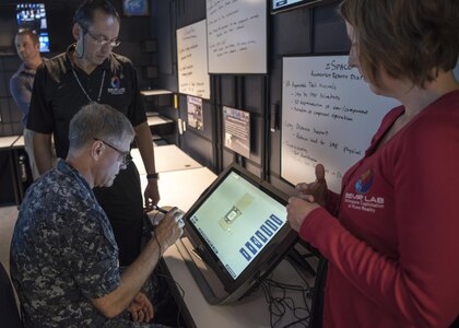 161104-N-LY160-043 PEARL HARBOR, Hawaii (Nov. 7, 2016) Rear Adm. Fritz Roegge, commander, Submarine Force U.S. Pacific Fleet (COMSUBPAC), participates in an augmented-reality demonstration at the official opening of the COMSUBPAC Innovation Lab (iLab) at Naval Submarine Training Center Pacifc in Joint Base Pearl Harbor-Hickam, Nov. 7. The iLab's mission is to provide Sailors with cutting-edge battlespace visualization capabilities using virtual and augmented reality. (U.S. Navy photo by Petty Officer 2nd Class Michael H. Lee/Released)
