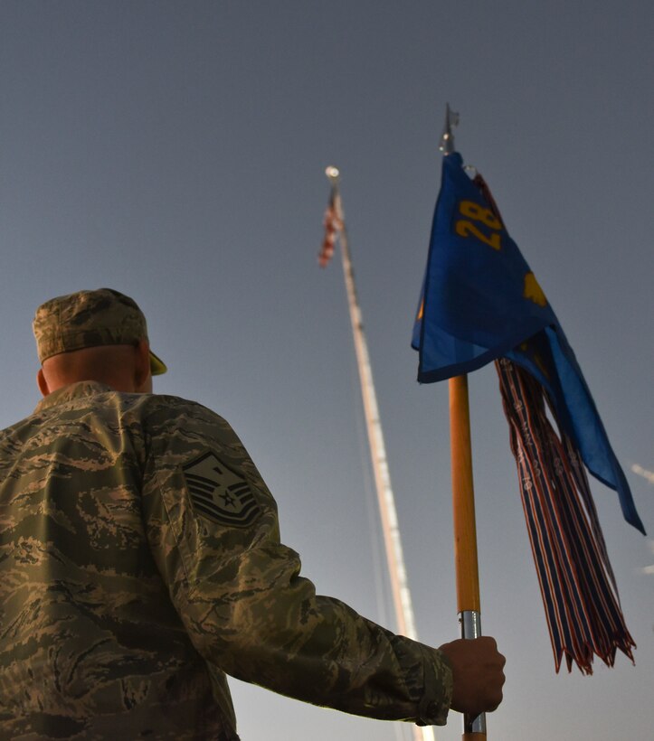 Master Sgt. Chet Fine, the first sergeant for the 28th Munitions Squadron, carries a guidon during a retreat ceremony at Ellsworth Air Force Base, S.D., on Nov. 10, 2016. The ceremony was performed in commemoration of Veterans Day, which has been a National Holiday every eleventh day of the eleventh month since President Dwight. D. Eisenhower issued the first Veterans Day Proclamation in 1938. (U.S. Air Force photo by Airman 1st Class Randahl J. Jenson)  