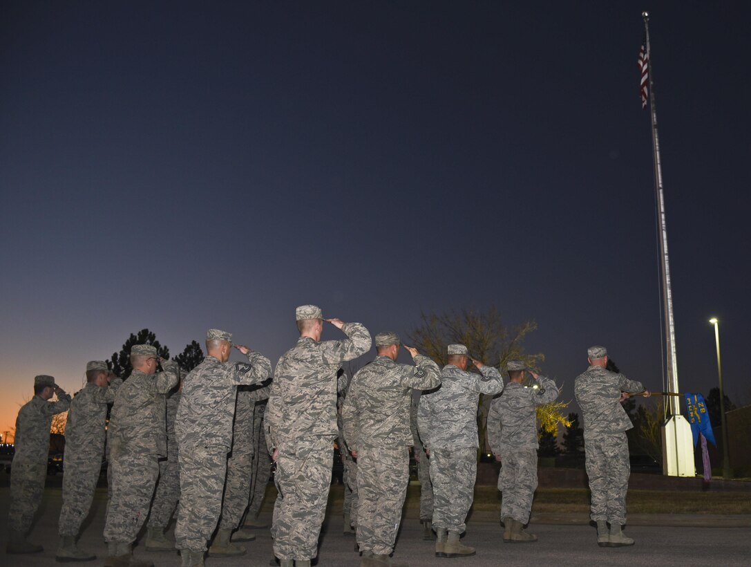 Members from the 28th Munitions Squadron render a salute during a retreat ceremony at Ellsworth Air Force Base, S.D., on Nov. 10, 2016. The ceremony was performed in commemoration of Veterans Day, which has been a National Holiday every eleventh day of the eleventh month since President Dwight. D. Eisenhower issued the first Veterans Day Proclamation in 1938. (U.S. Air Force photo by Airman 1st Class Randahl J. Jenson) 