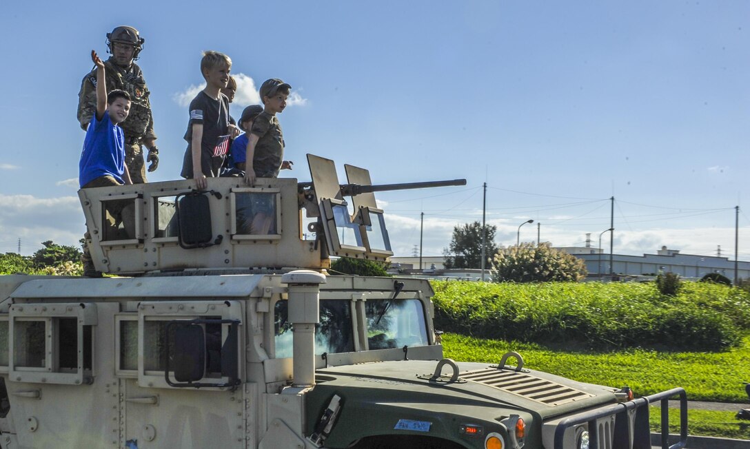 Members of the 353rd Special Operations Group and their families during the Veterans Day parade, Nov. 11, 2016 on Kadena Air Base, Japan. Veterans and their families across the globe take time gathering together, for their service and the service of others and in celebration. (U.S. Air Force photo by Airman 1st Class Nick Emerick/Released)