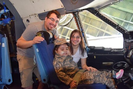 Five-year-old Mayra Salinas, flanked by her parents Gabriel Salinas Jr. and Ashely Salinas, sits in the pilot seat of a 433rd Airlift Wing C-5M Super Galaxy Nov. 5, 2016 at Joint Base San Antonio-Lackland, Texas. The 433rd Airlift Wing Rising 6, a private organization comprised of Airmen grade E-1 through E-6, honored Mayra as the wing's Airman of the Day. (U.S. Air Force photo/Tech. Sgt. Carlos J. Treviño/Released)
