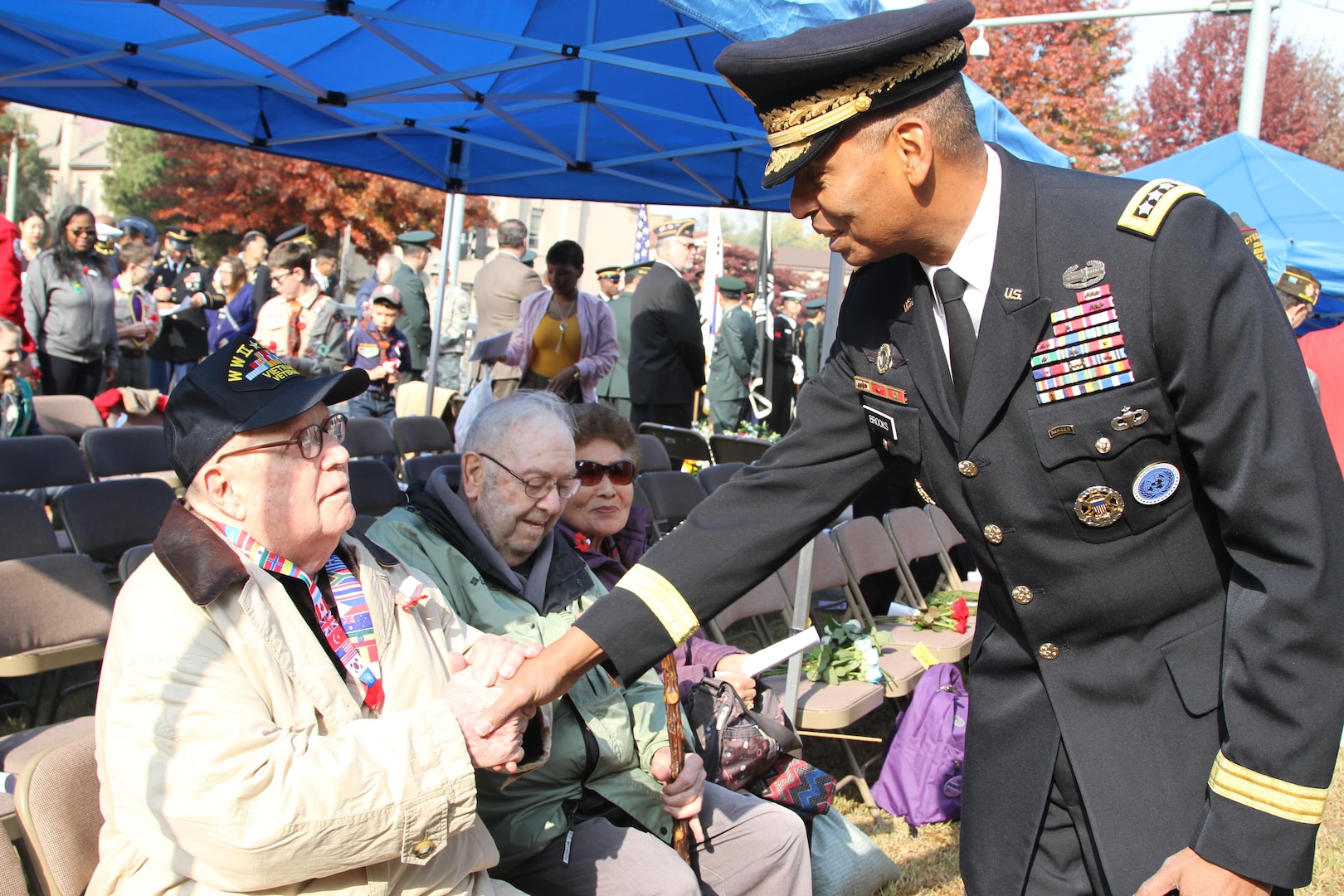 General Vincent K. Brooks, commander of United Nations Command, Combined Forces Command, and U.S. Forces Korea speaks with war veterans attending Veterans Day ceremony at the Eighth Army Memorial, Yongsan, Republic of Korea, Nov. 11, 2016.

