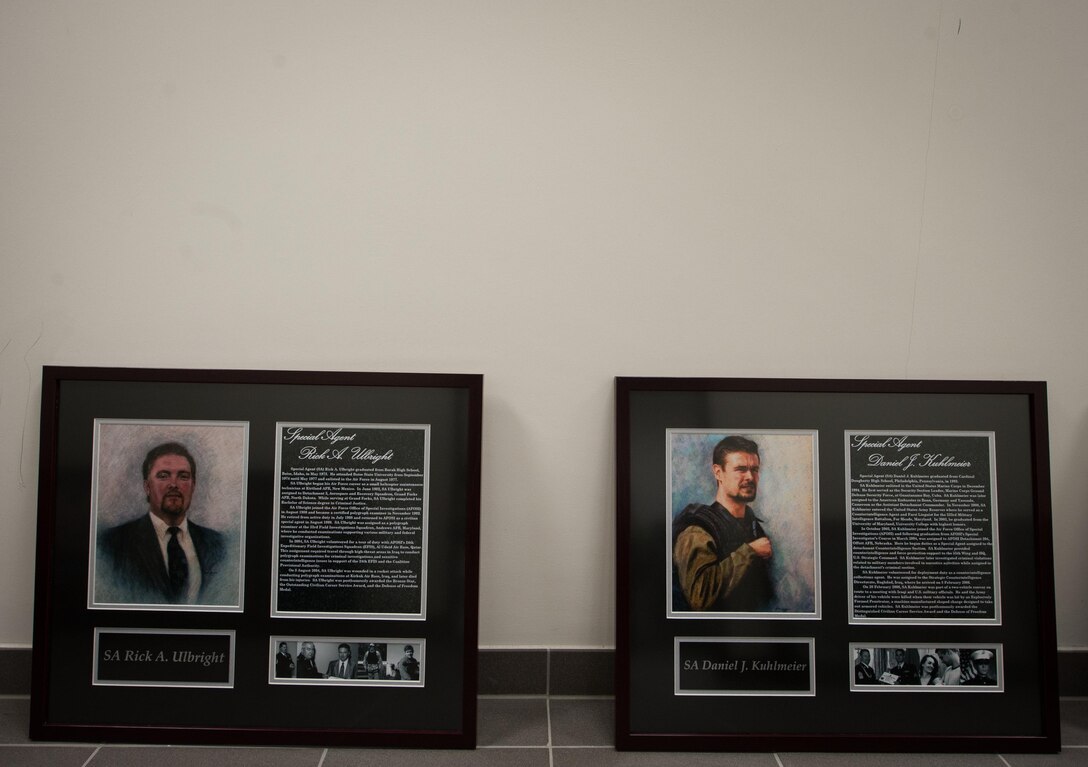 Two portraits of fallen Air Force Office of Special Investigations Airmen lay on the floor during the 25th Expeditionary Field Investigation Squadron’s fallen heroes dedication ceremony at Ramstein Air Base, Germany, Nov. 10, 2016. The 25th EFIS held the ceremony to commemorate AFOSI agents who lost their lives in the line of duty. Veteran’s Day is a celebration to honor America's veterans for their patriotism, love of country, and willingness to serve and sacrifice, even if it means their lives. According to a recent Congressional Research Service report, more than 6,500 U.S. service members have lost their lives in post-9/11 conflicts in Iraq and Afghanistan. (U.S. Air Force photo by Airman 1st Class Lane T. Plummer)