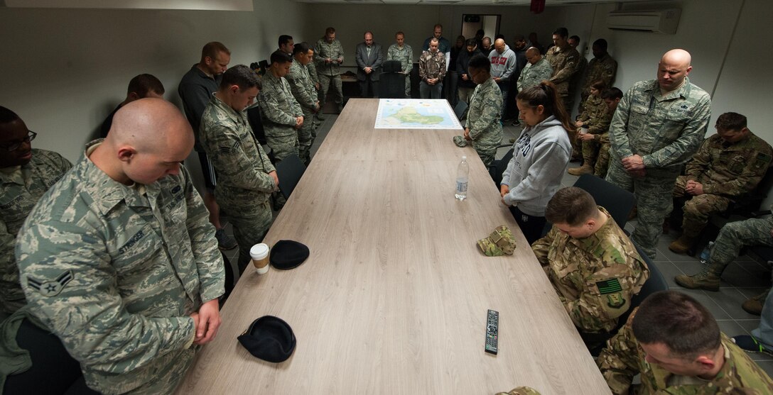 Airmen pray during the 25th Expeditionary Field Investigation Squadron’s fallen heroes dedication ceremony at Ramstein Air Base, Germany, Nov. 10, 2016. Airmen gathered to honor Air Force Office of Special Investigation agents who have fallen during the line of duty. Veteran’s Day is a celebration to honor America's veterans for their patriotism, love of country, and willingness to serve and sacrifice, even if it means their lives. According to a recent Congressional Research Service report, more than 6,500 U.S. service members have lost their lives in post-9/11 conflicts in Iraq and Afghanistan. (U.S. Air Force photo by Airman 1st Class Lane T. Plummer)