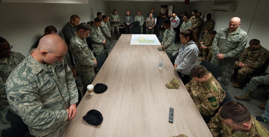Airmen pray during the 25th Expeditionary Field Investigation Squadron’s fallen heroes dedication ceremony at Ramstein Air Base, Germany, Nov. 10, 2016. Airmen gathered to honor Air Force Office of Special Investigation agents who have fallen during the line of duty. Veteran’s Day is a celebration to honor America's veterans for their patriotism, love of country, and willingness to serve and sacrifice, even if it means their lives. According to a recent Congressional Research Service report, more than 6,500 U.S. service members have lost their lives in post-9/11 conflicts in Iraq and Afghanistan. (U.S. Air Force photo by Airman 1st Class Lane T. Plummer)