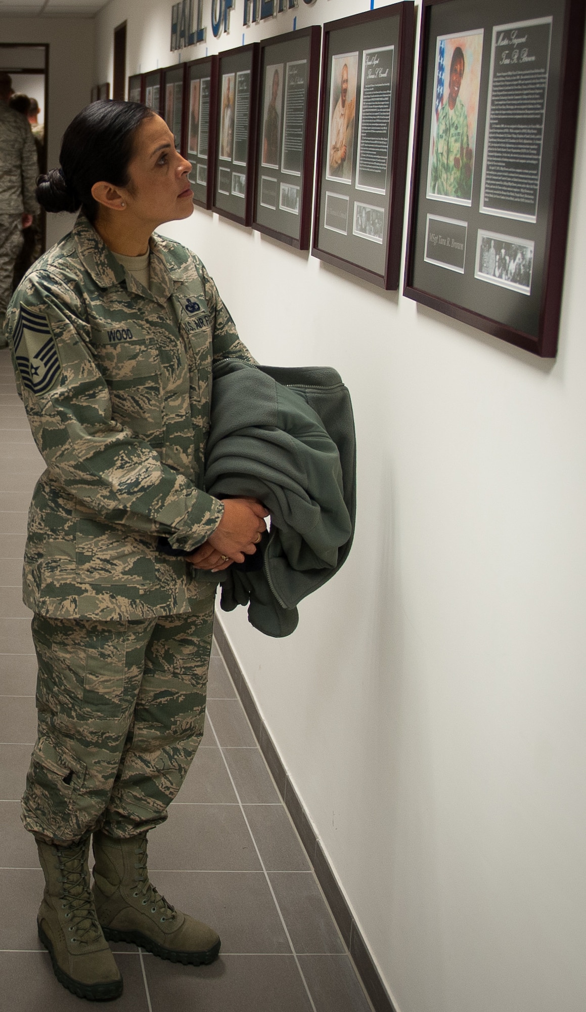 Chief Master Sgt. Roelma Wood, 4th Air Force Installation, Mission Support Center security forces major command functional manager, observes the portrait of a deceased Office of Special Investigations agent during the 25th Expeditionary Field Investigation Squadron’s fallen heroes dedication ceremony at Ramstein Air Base, Germany, Nov. 10, 2016. Airmen gathered to honor Air Force OSI agents who have fallen during the line of duty. Veteran’s Day is a celebration to honor America's veterans for their patriotism, love of country, and willingness to serve and sacrifice, even if it means their lives. According to a recent Congressional Research Service report, more 6,500 U.S. servicemembers have lost their lives in post-9/11 conflicts in Iraq and Afghanistan. (U.S. Air Force photo by Airman 1st Class Lane T. Plummer)