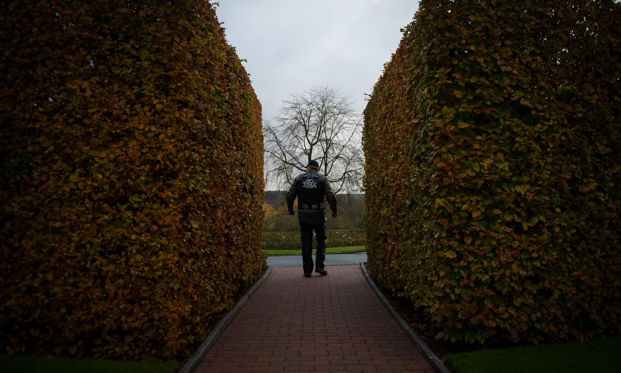 A member of the Ramstein military motorcycle club from the Kaiserslautern Military Community walks through the entrance of the Lorraine American Cemetery Nov. 11, 2016, at St. Avold, France. Veterans Day is observed annually on November 11 and commemorates military veterans who currently serve or have served the U.S. armed forces, including those who gave the ultimate sacrifice. According to the DoD and Veterans Administration, since World War I, approximately 624,000 U.S. servicemembers have been killed in action battling in wars and conflicts. The Lorraine American Cemetery contains the buried remains of over 10,000 of them. It is the largest burial site of U.S. servicemembers in Europe. (U.S. Air Force photo by Airman 1st Class Lane T. Plummer)
