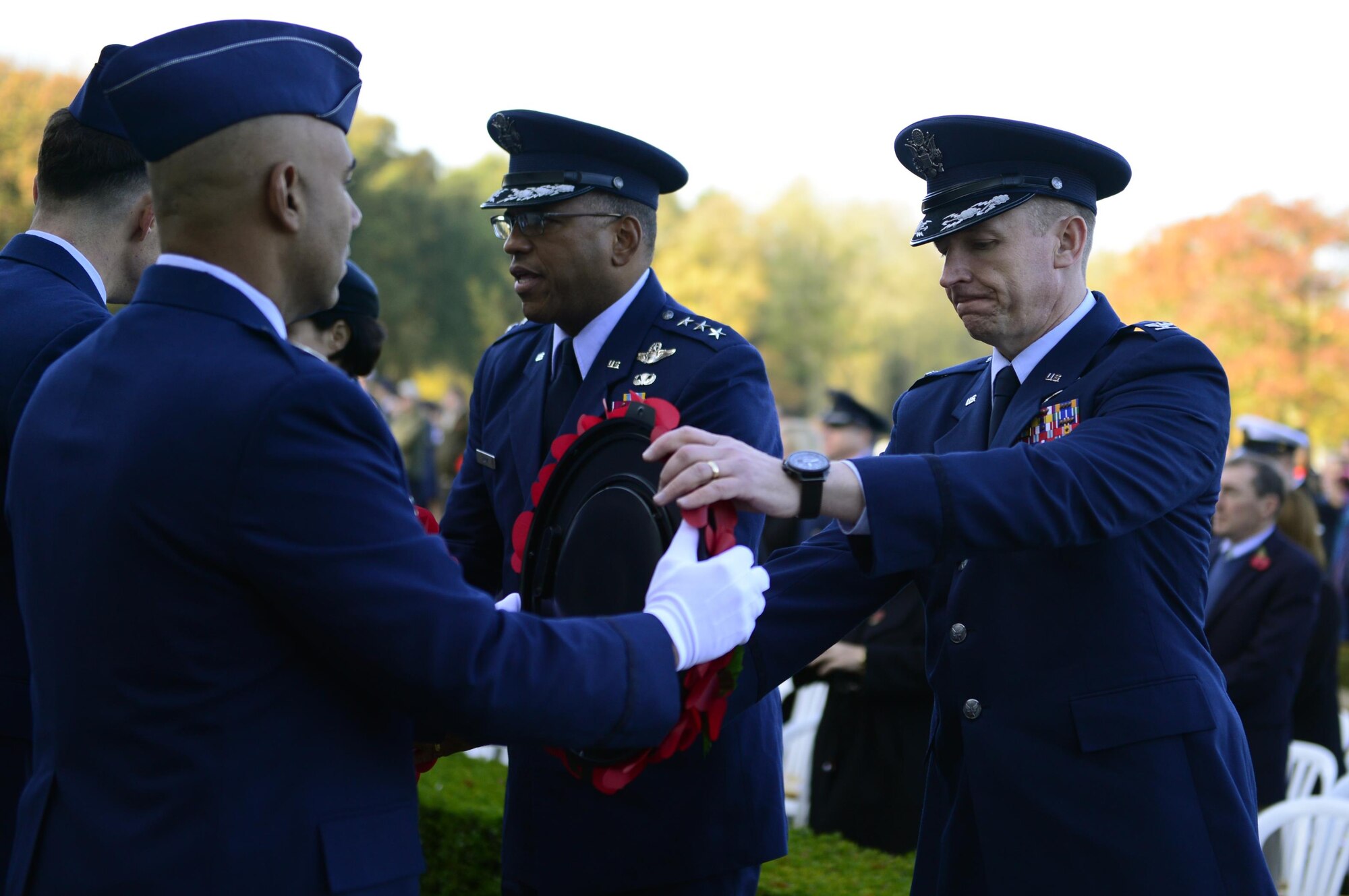 U.S. Air Force Col. Evan Pettus, 48th Fighter Wing commander, receives a wreath at the Cambridge American Cemetery in Cambridge, England, Nov. 11. Distinguished visitors and veterans were invited to participate in the ceremony by placing wreathes along the Tablets of the Missing. (U.S. Air Force photo/Senior Airman Malcolm Mayfield) 
