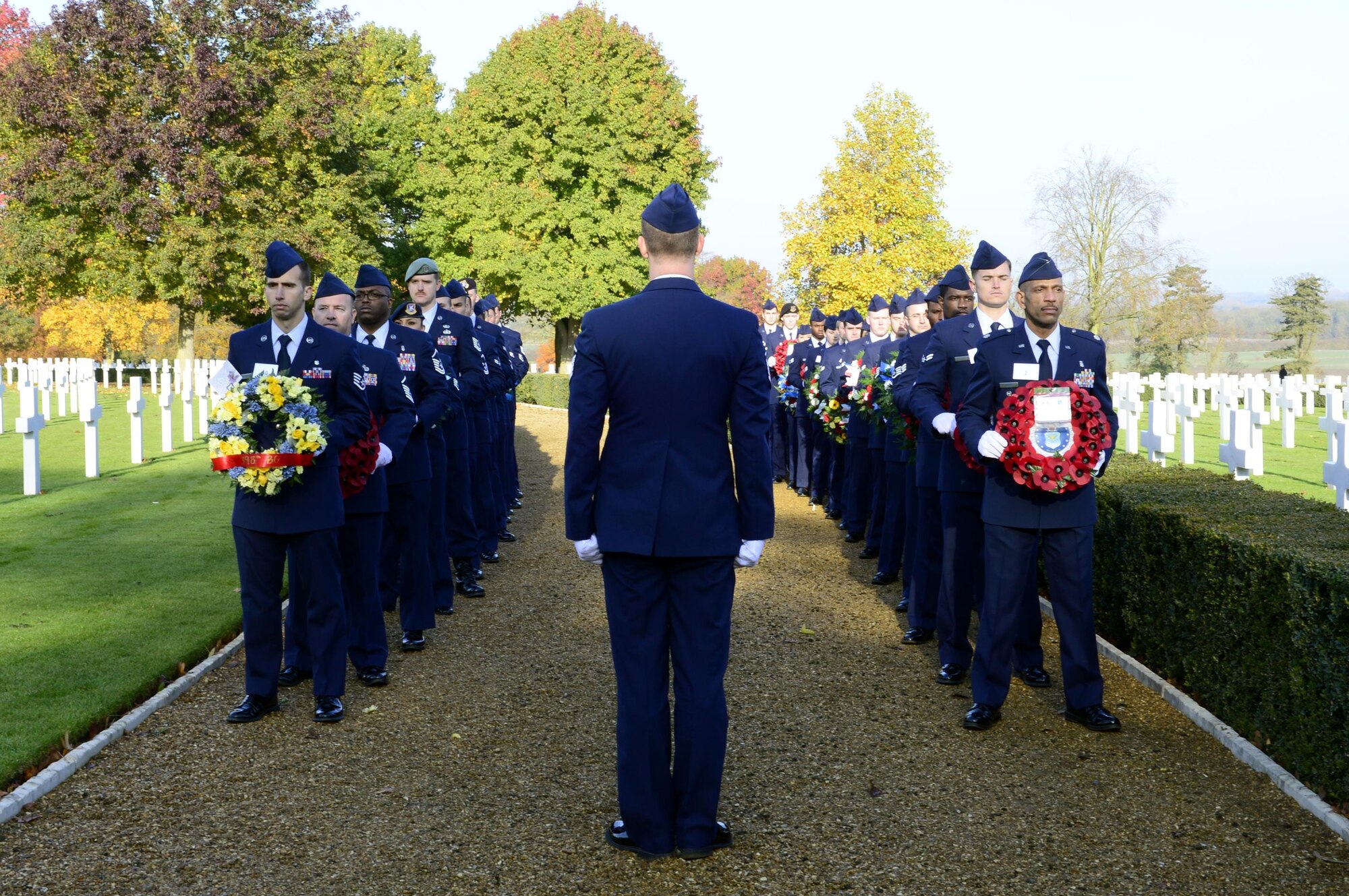 U.S. Air Force Airmen act as wreath bearers during a Veterans Day ceremony at the Cambridge American Cemetery in Cambridge, England, Nov. 11. Distinguished visitors and veterans were invited to participate in the ceremony by placing wreathes along the Tablets of the Missing. (U.S. Air Force photo/Senior Airman Malcolm Mayfield)
