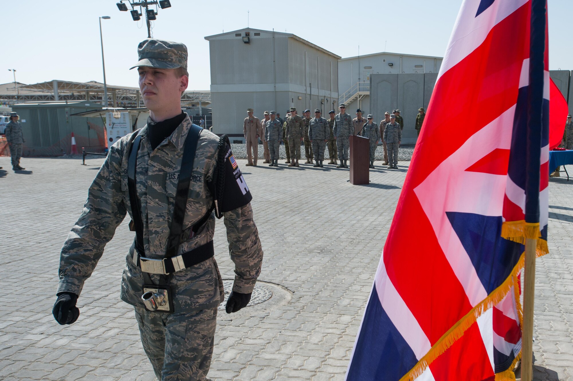 A 380th Air Expeditionary Wing Honor Guard service member marches in formation after placing the U.S. flag at a Coalition Veteran’s Day ceremony on Nov. 11, 2016 at an undisclosed location in Southwest Asia.  The 380 AEW Honor Guard collaborated with service members from the Royal Australian Air Force, the Royal Danish Air Force and the Royal Air Force. (U.S. Air Force photo by Senior Airman Tyler Woodward)