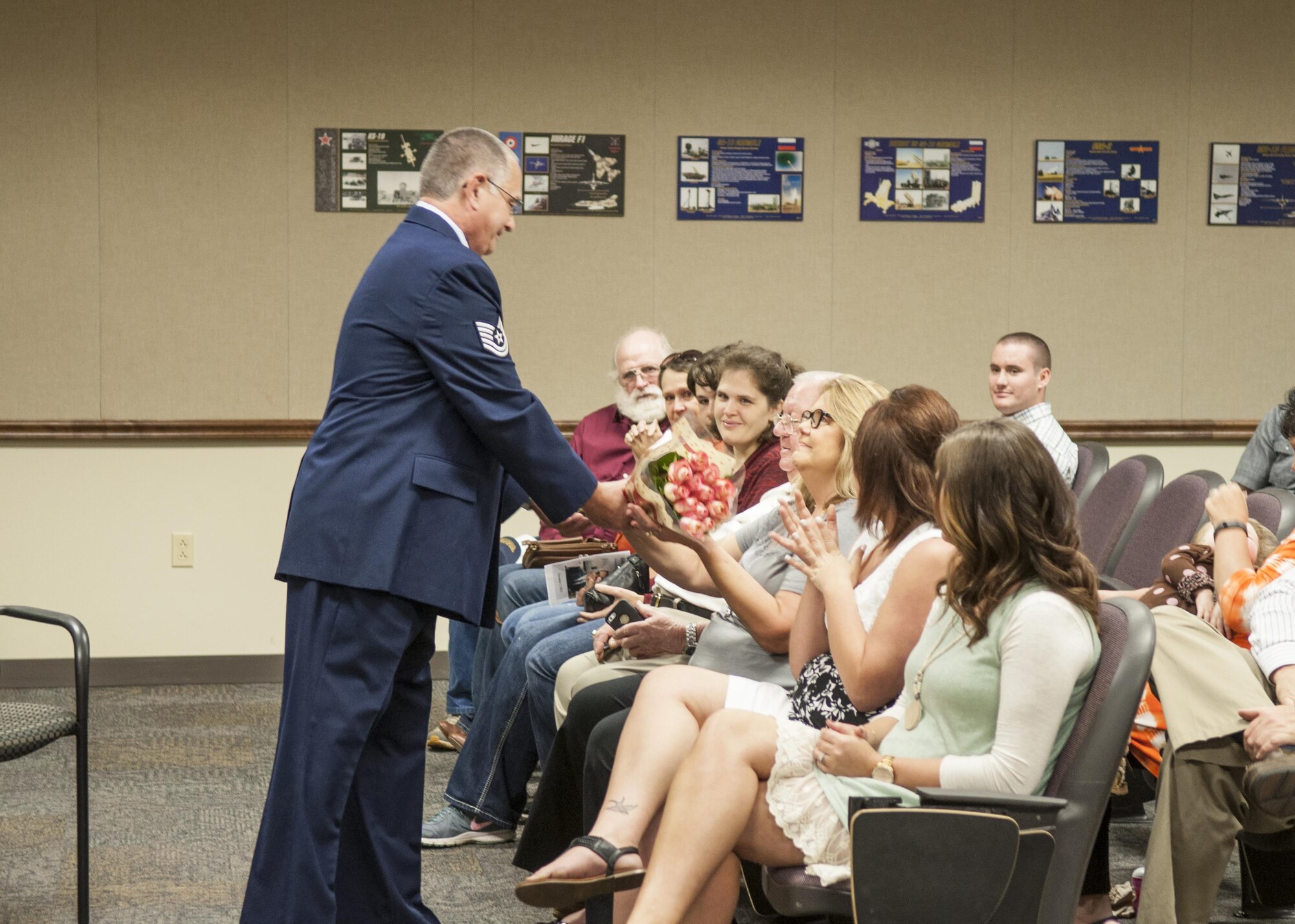 U.S. Air Force Tech. Sgt. Paul Motter, 307th Operations Support Squadron, presents his wife, Kellie, with flowers to show his appreciation for her support during his retirement ceremony on Nov. 5, 2016, Barksdale Air Force Base, La. Motter is assigned to the 307th Operations Support Squadron and is retiring after 33 years of military service. (U.S. Air Force photo by Tech. Sgt. Cody Burt/Released)