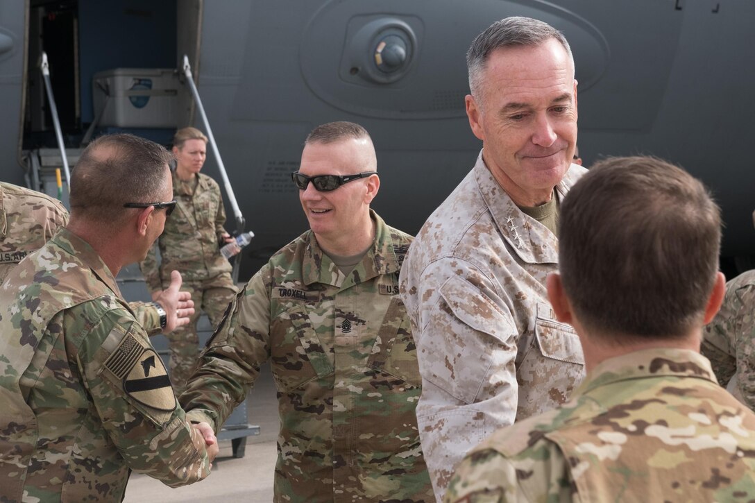 Marine Corps Gen. Joe Dunford, second from right, chairman of the Joint Chiefs of Staff, and Army Command Sgt. Maj. John W. Troxell, center, the chairman's senior enlisted adviser, speak with service members in Irbil, Iraq, Nov. 10, 2016. DoD photo by D. Myles Cullen