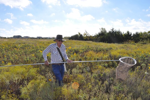 Volunteer insect collector John Lee wades through the Scissortail Trail Area at Tinker Air Force Base, Okla., on a recent bug-hunting outing. (Air Force photo by John Parker)
