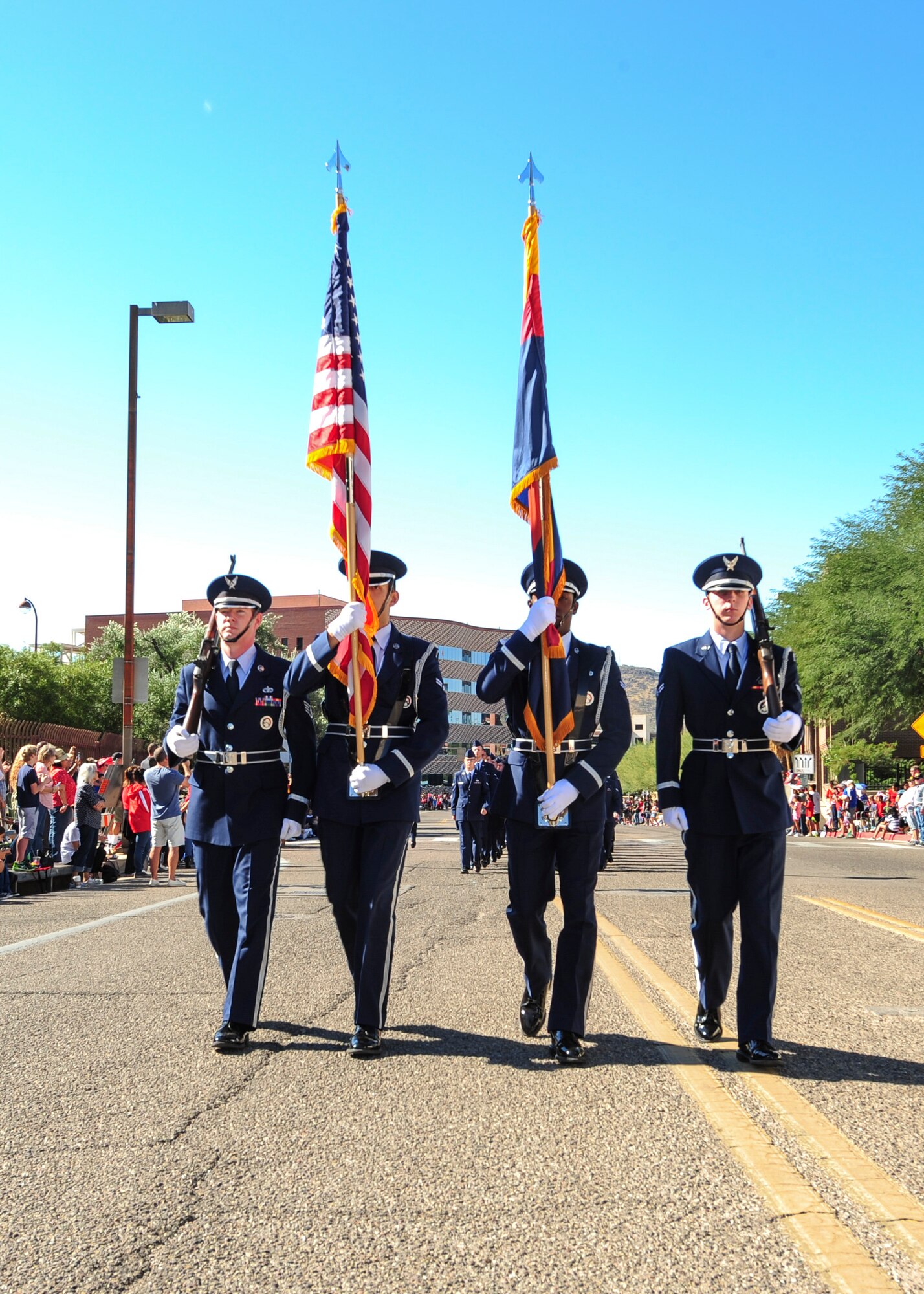 U.S. Airmen from the Davis-Monthan Air Force Base Honor Guard lead a formation during the Tucson Veterans Day Parade in Tucson, Ariz., Nov. 11, 2016. The Base Honor Guard represents the U.S. Air Force in ceremonies and celebrations throughout the year. (U.S. Air Force photo by Airman Nathan H. Barbour)