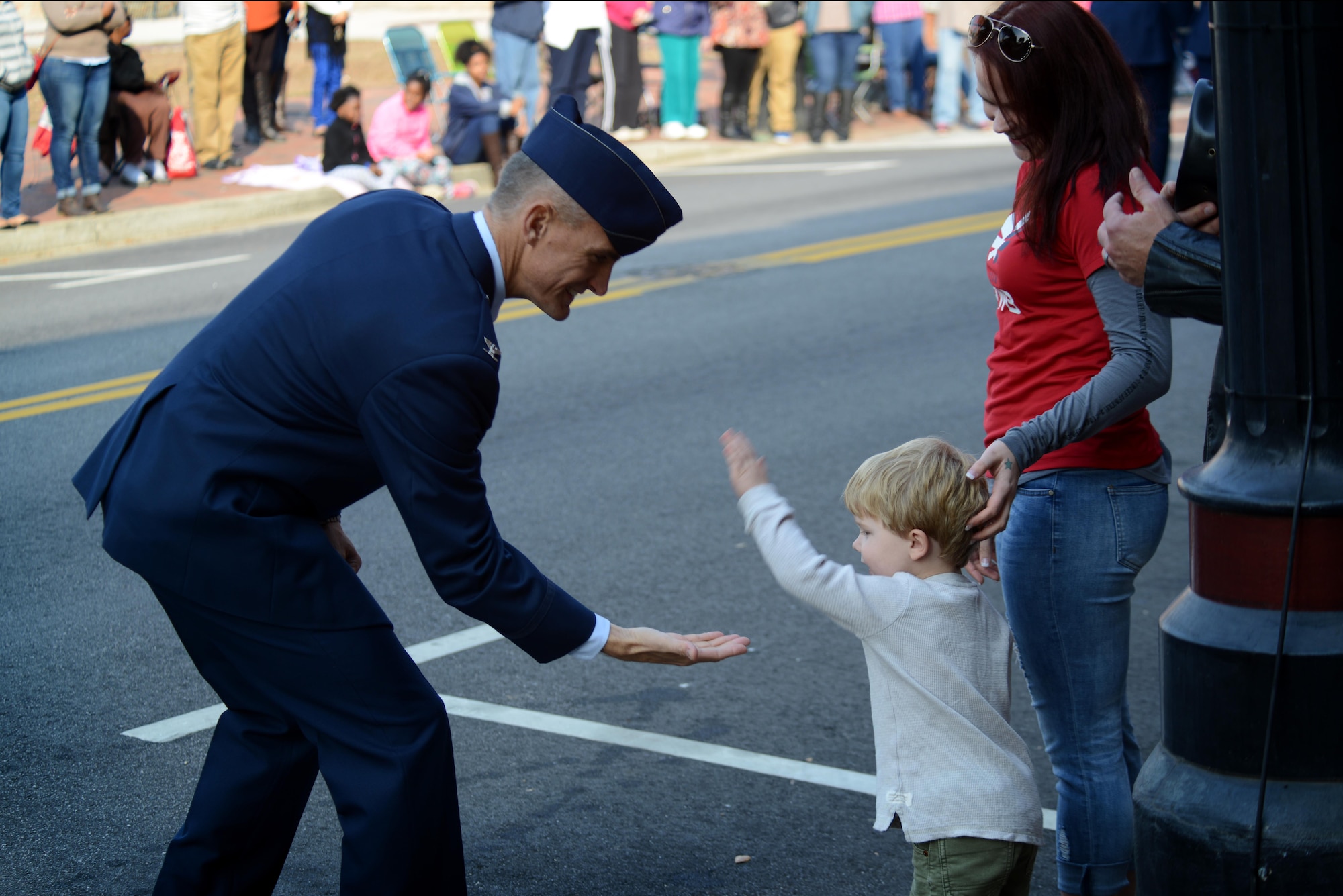 U.S. Air Force Col. Daniel Lasica, 20th Fighter Wing commander, high-fives a child during a Veterans Day parade, Sumter, S.C., Nov. 11, 2016. Airmen from the 20th FW participated in the parade alongside other representatives from surrounding communities. (U.S. Air Force photo by Airman 1st Class Kelsey Tucker)
